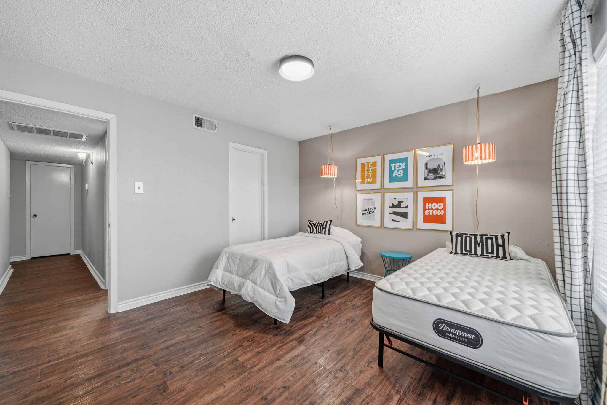 Cozy bedroom with twin beds and stylish decor, perfect for a restful stay.