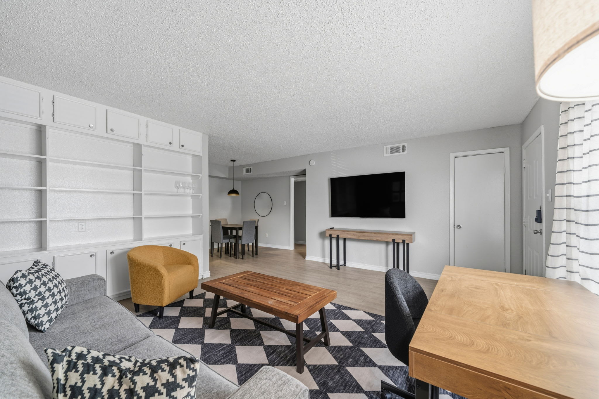 Spacious living room with modern decor, perfect for relaxation and entertainment.