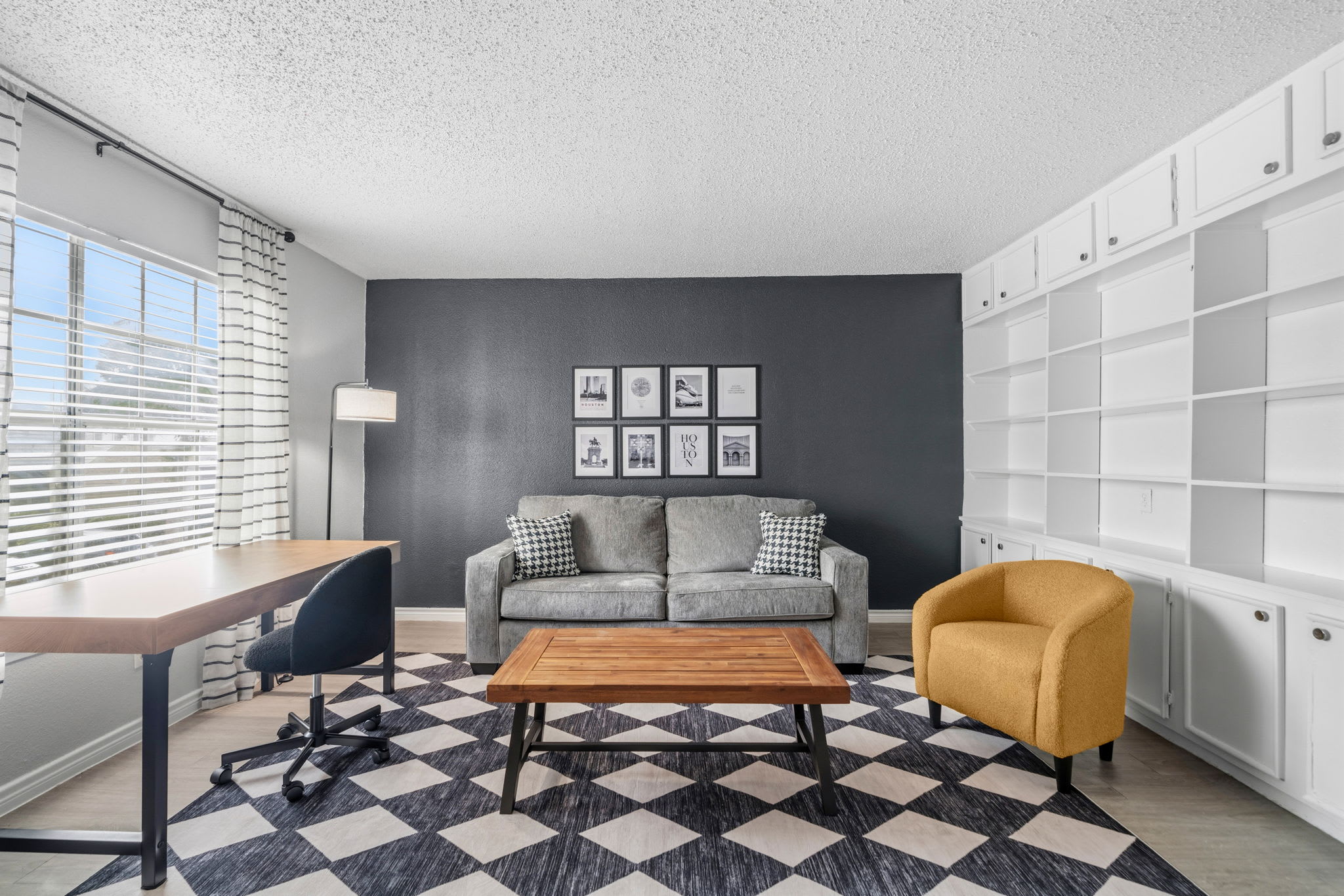 Bright and stylish living area with workspace, perfect for relaxation and productivity.