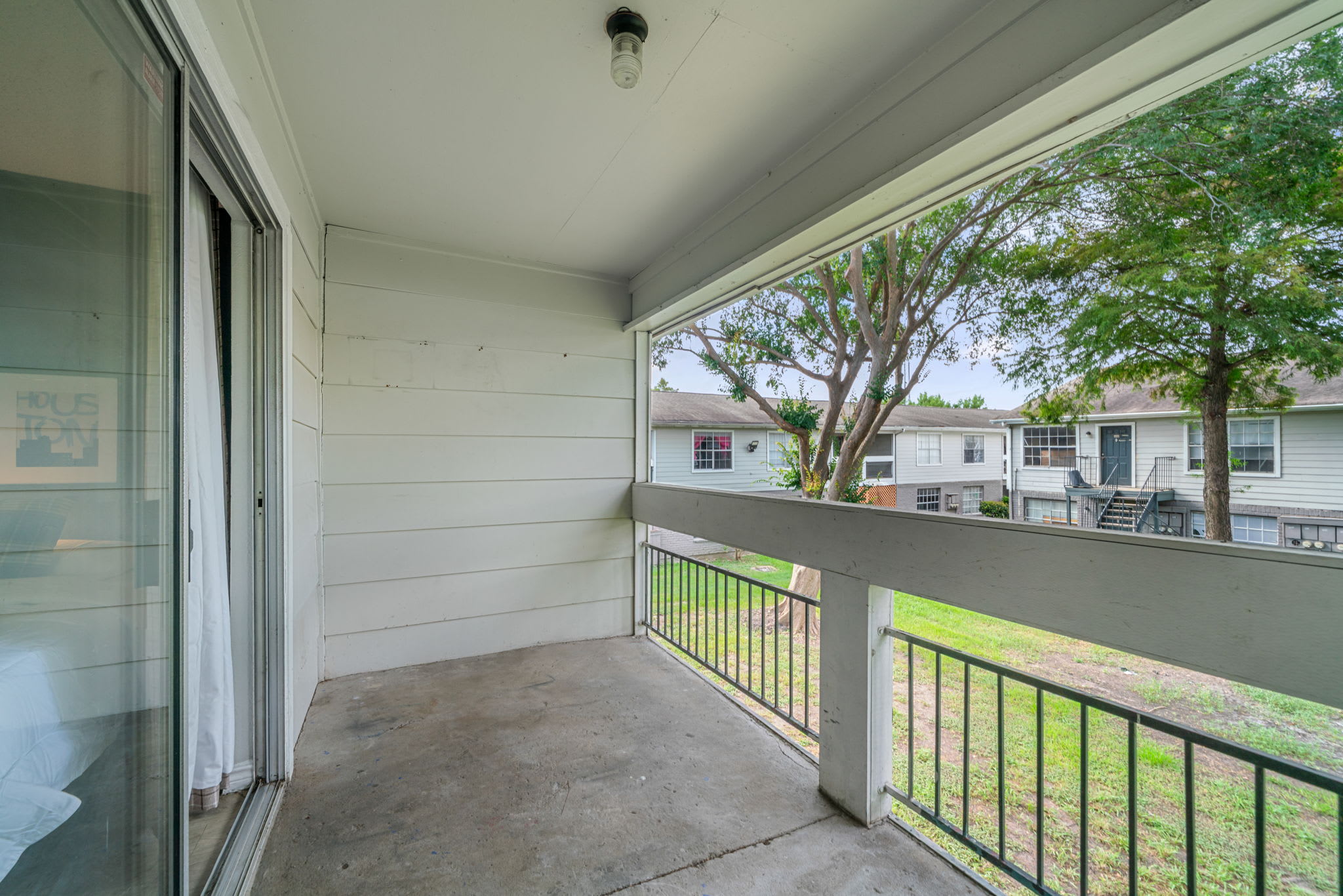 Relax on your private balcony with serene views of the neighborhood greenery.