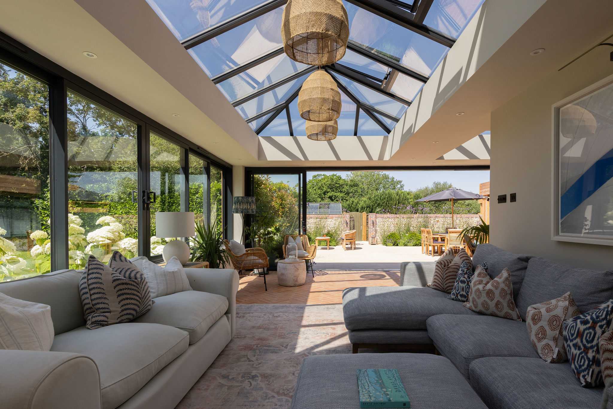 Sun-filled conservatory with plush seating and seamless access to the spacious garden terrace