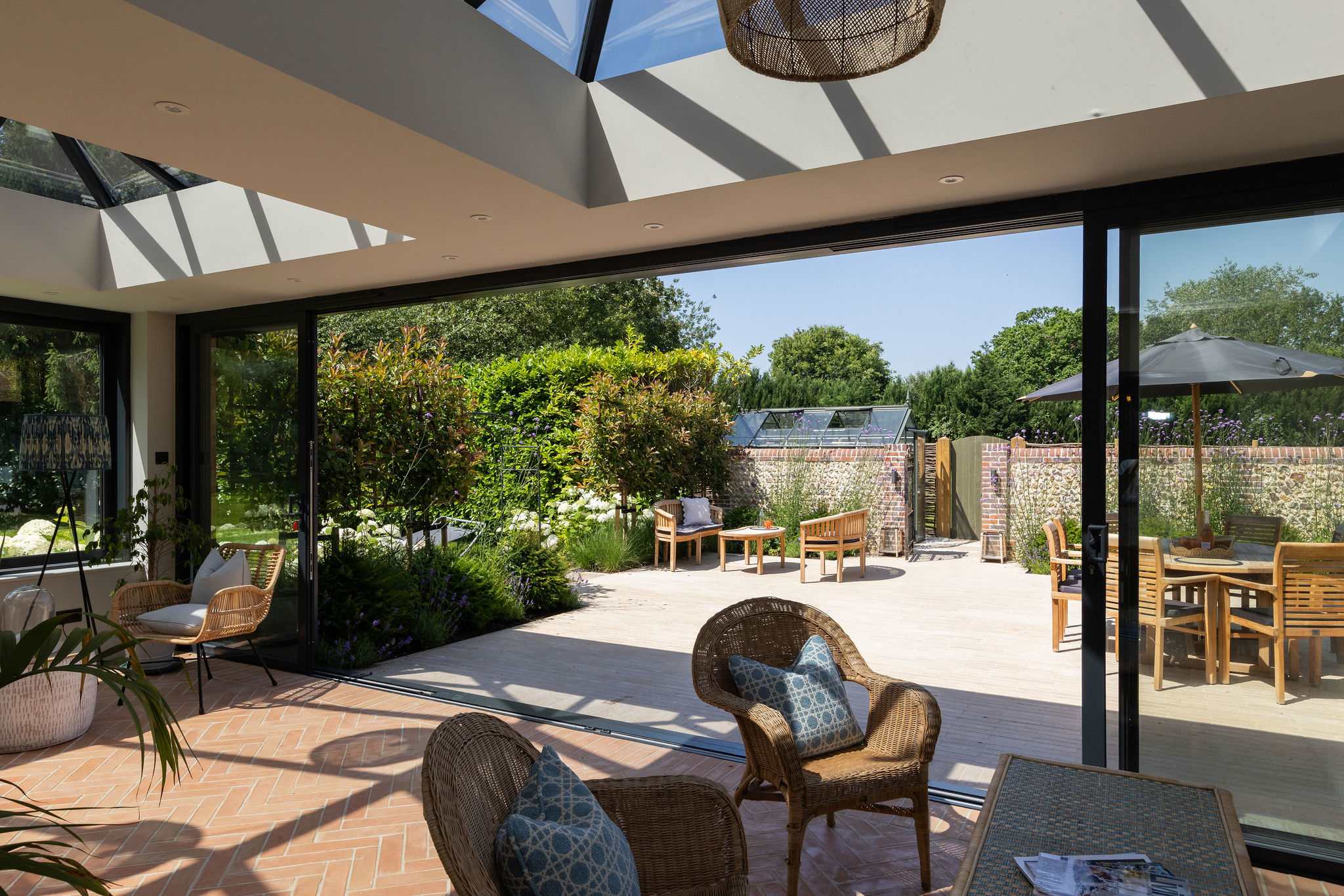 Open-plan conservatory overlooking the outdoor dining terrace, perfect for effortless indoor-outdoor living