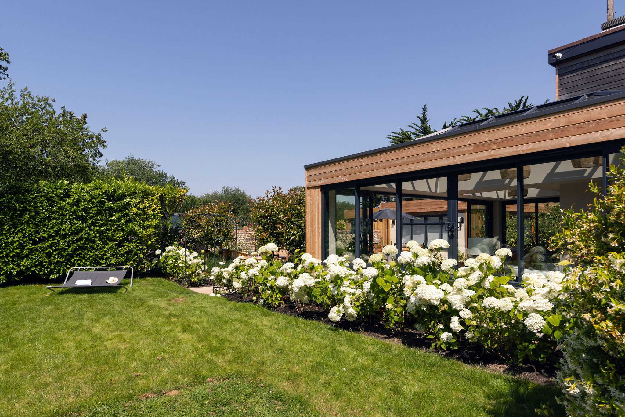 Landscaped garden with manicured lawn, offering a peaceful setting for outdoor relaxation