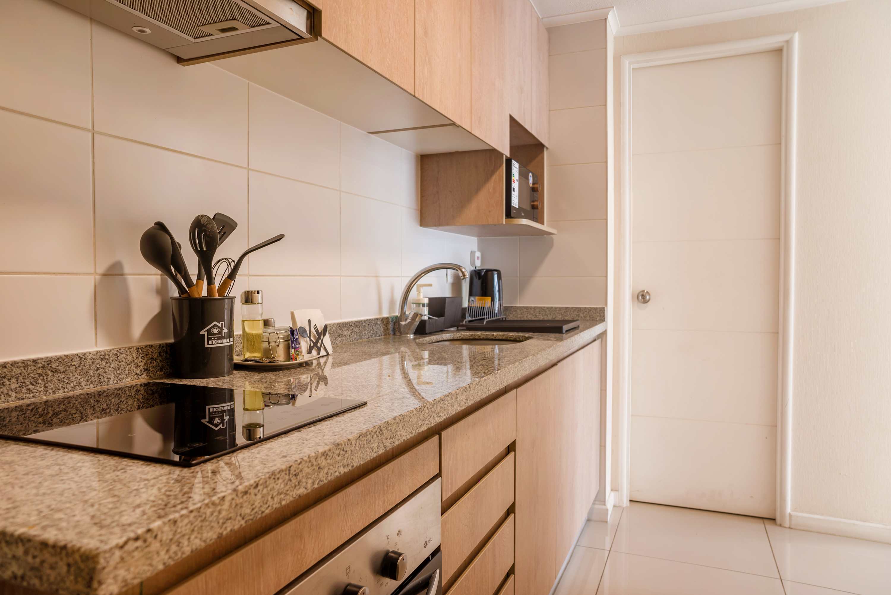 Sleek and modern kitchen equipped with all essentials for a comfortable stay in the heart of the city.