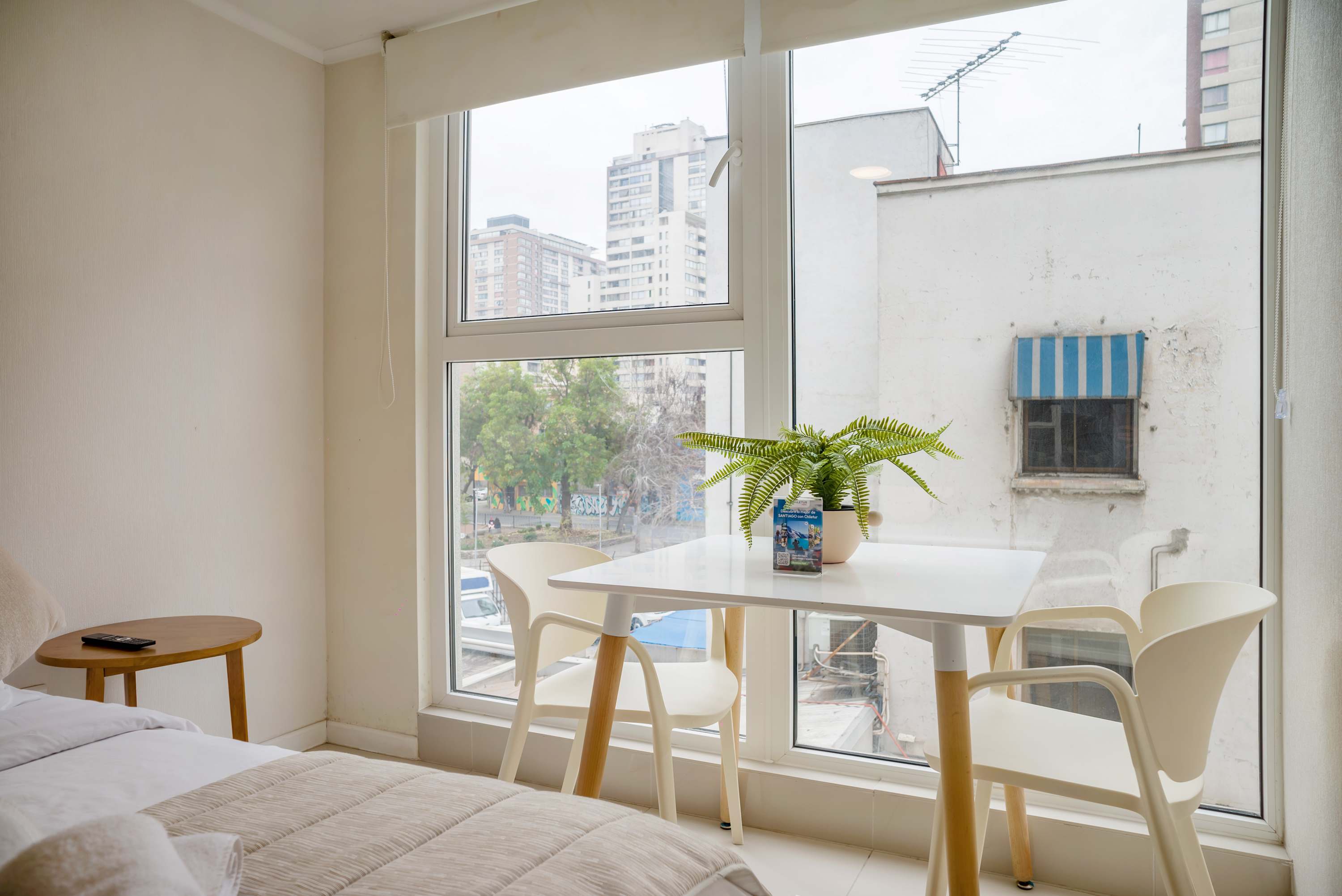 Enjoy a cozy meal with a view in this bright and airy studio apartment.