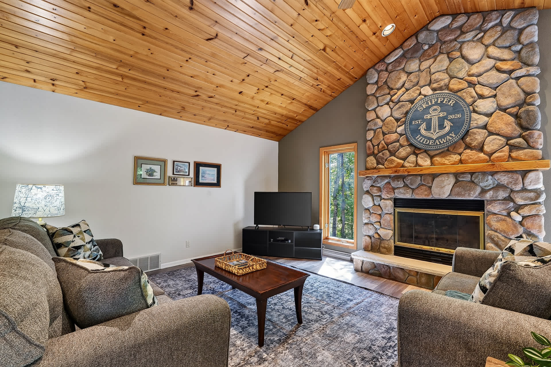 Large open concept living room, TV, Stone fireplace and plenty of seating for the whole family