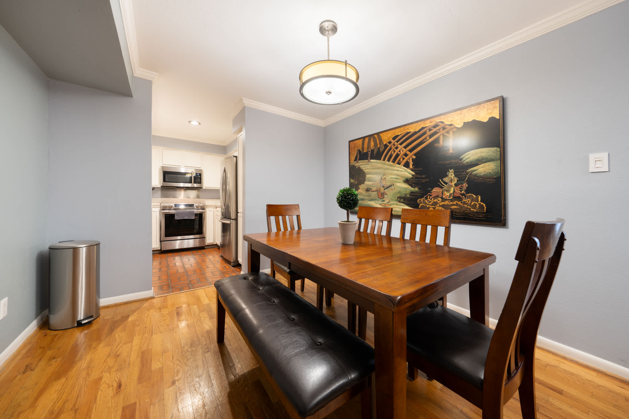 Spacious dining area with elegant wooden furniture and modern kitchen access, perfect for family meals.