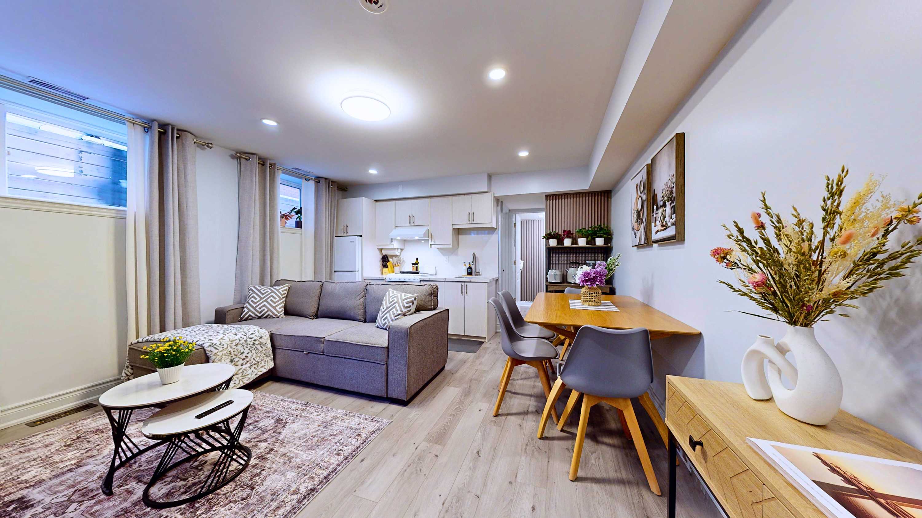Seamless flow between the relaxing couch area the dining table for three and the handy kitchen setup