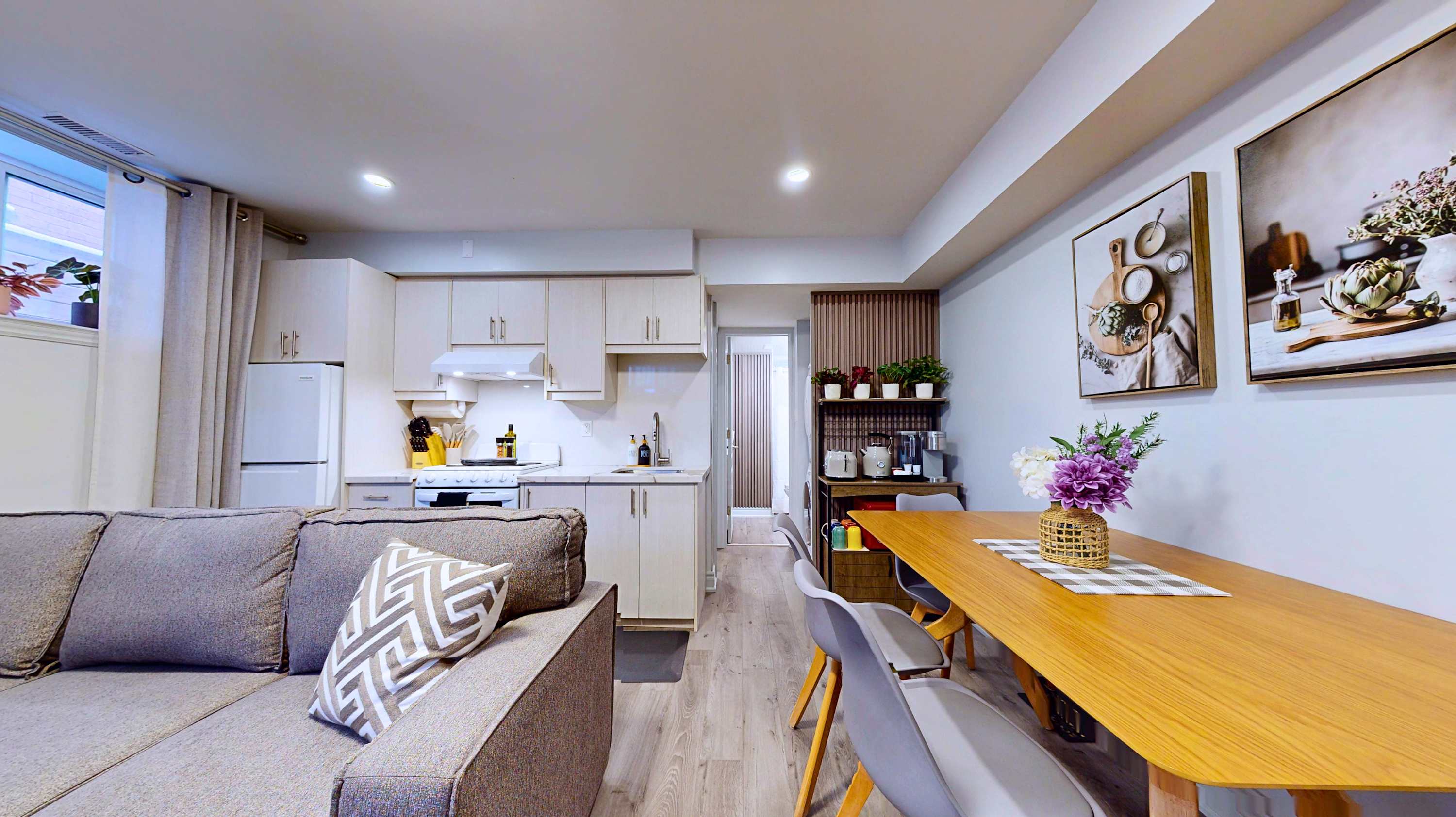 Enjoy a smart layout with a comfortable couch dining area kitchen and practical side shelves for your needs