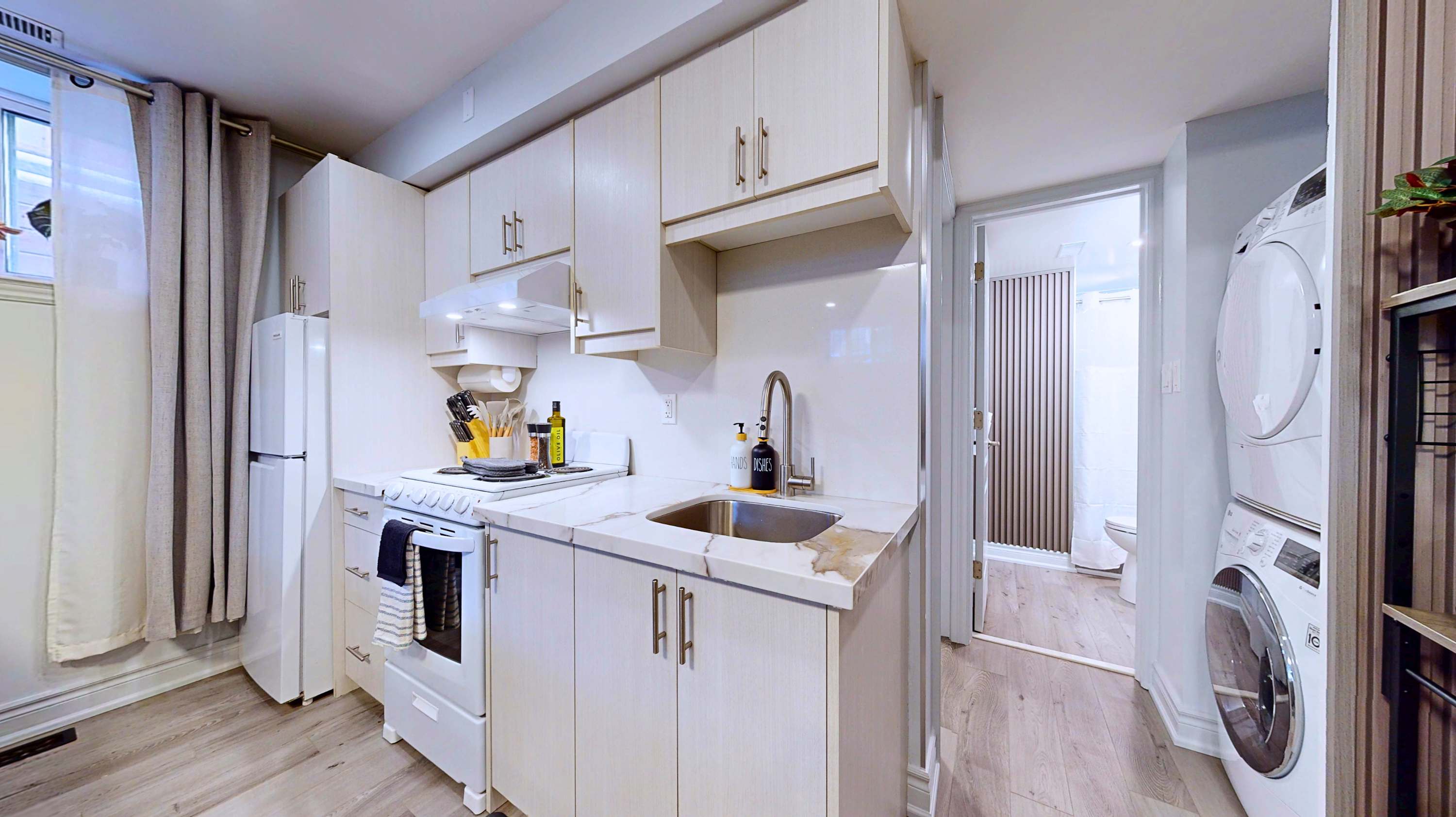 Modern kitchen space featuring an integrated washer and dryer setup