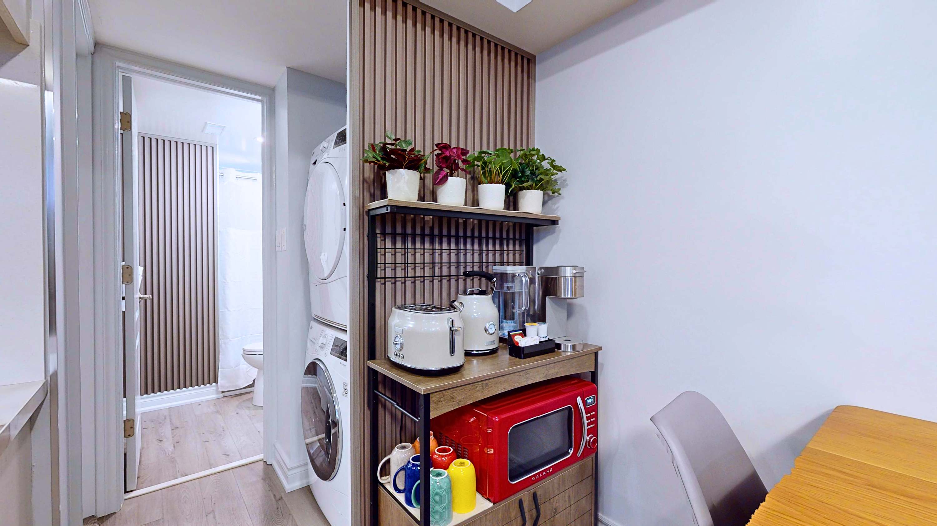 Convenient kitchen corner with breakfast essentials and a divided laundry space