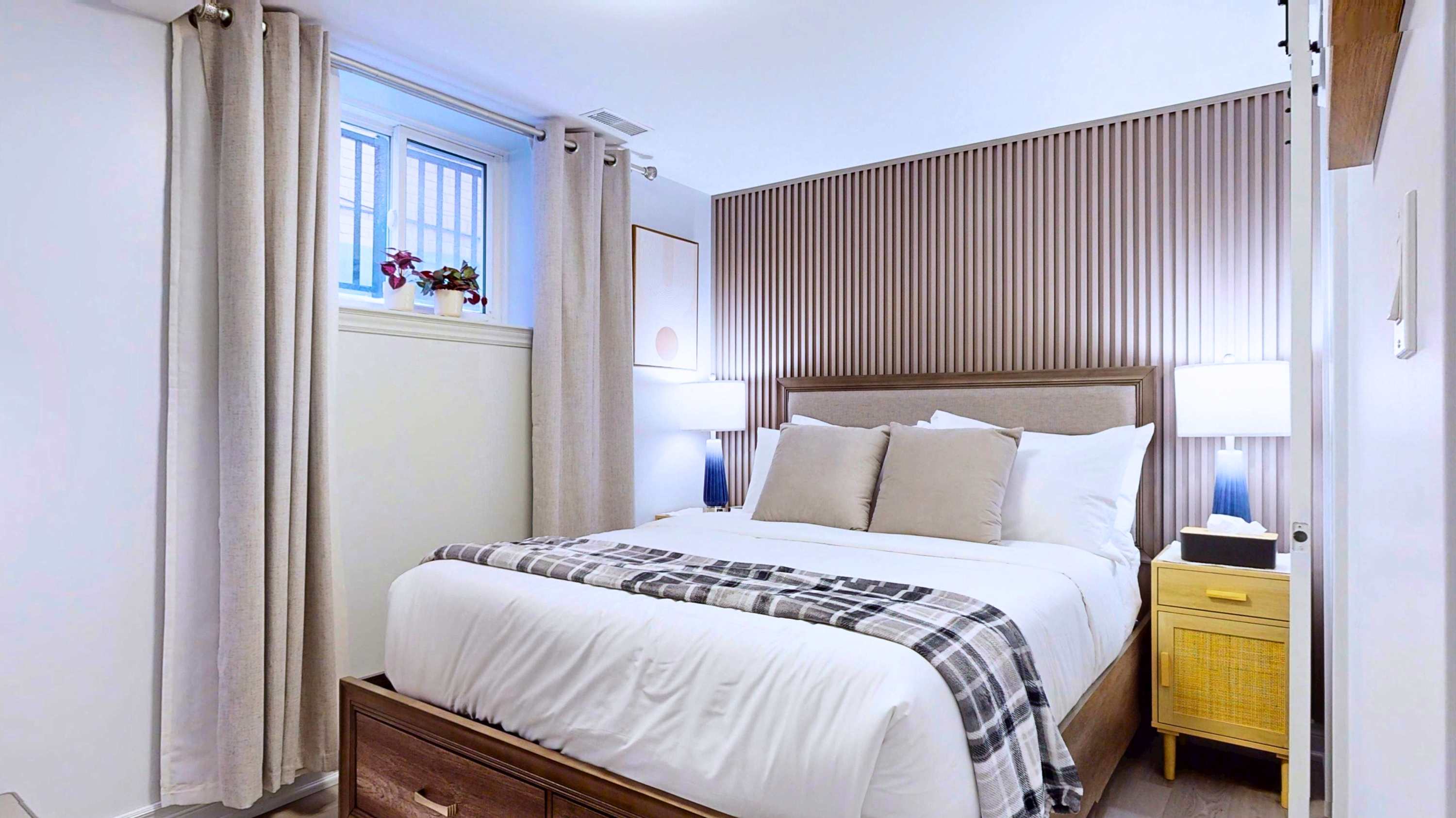 Relaxing queen bed featuring warm side lamps for a cozy evening vibe