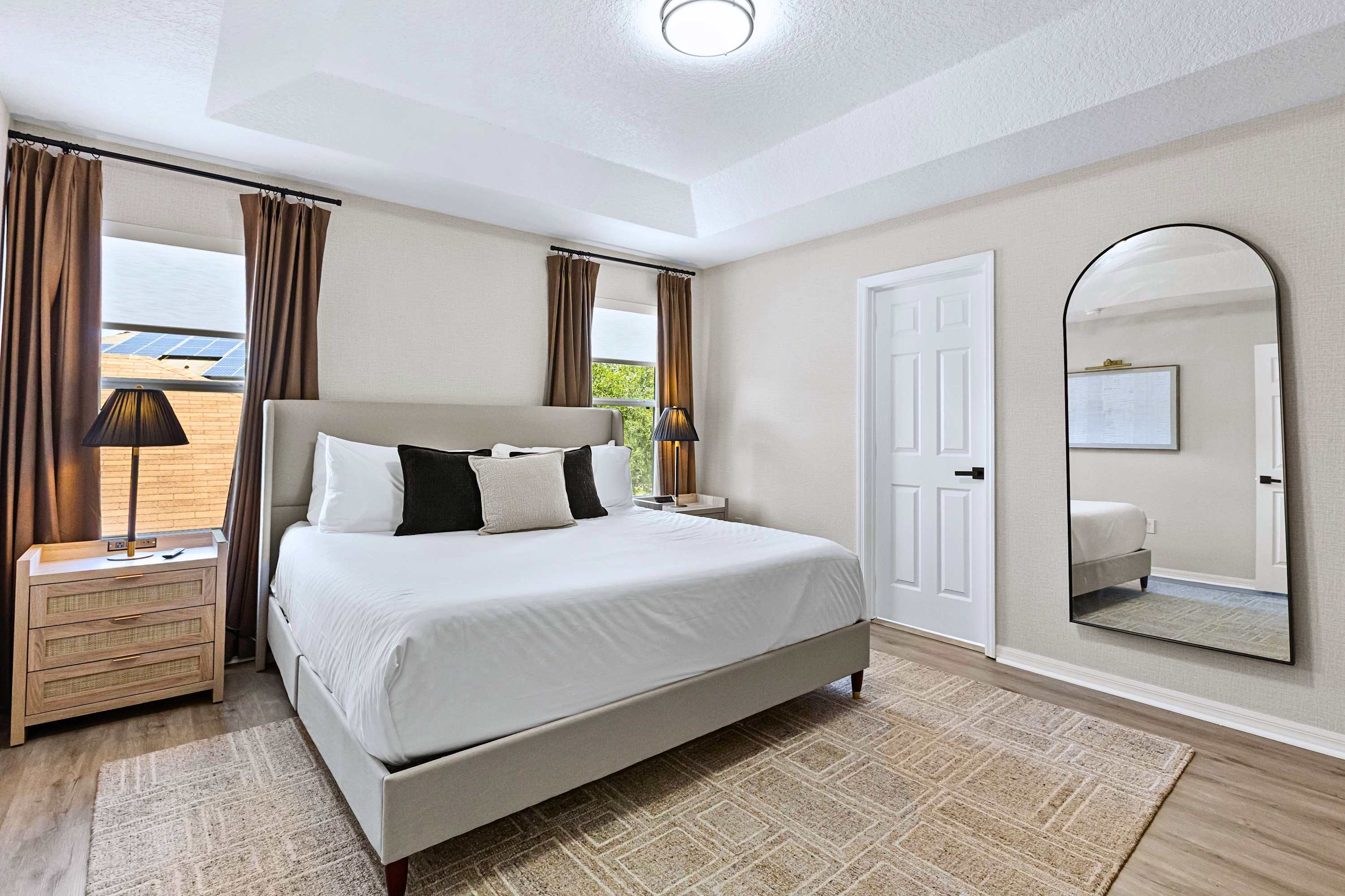 A dream bedroom setup. Enjoy cozy nights with warm side lighting and a spacious mirror to help you get ready for the day
