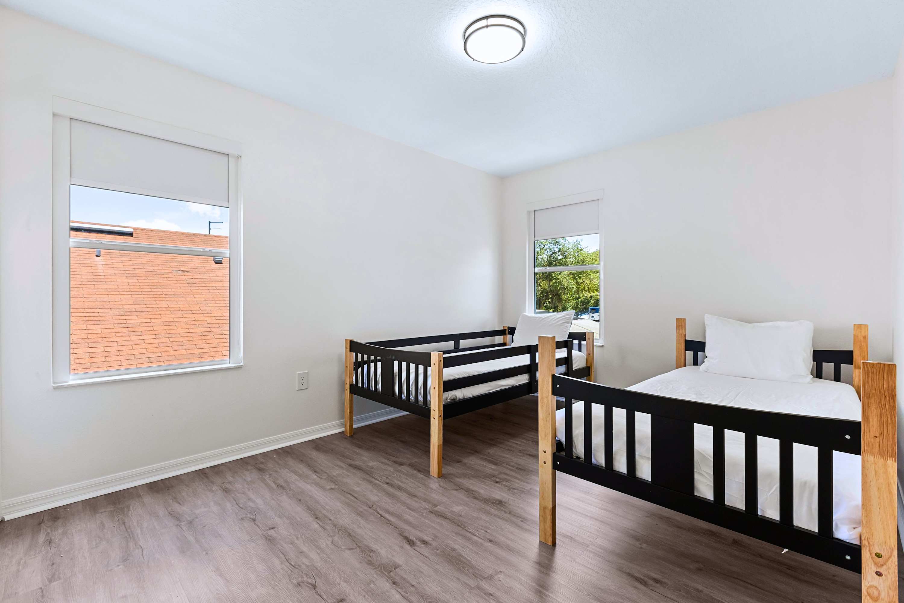 Sleek and spacious comfort. Two single beds with premium linens and large windows for a bright, clean feel