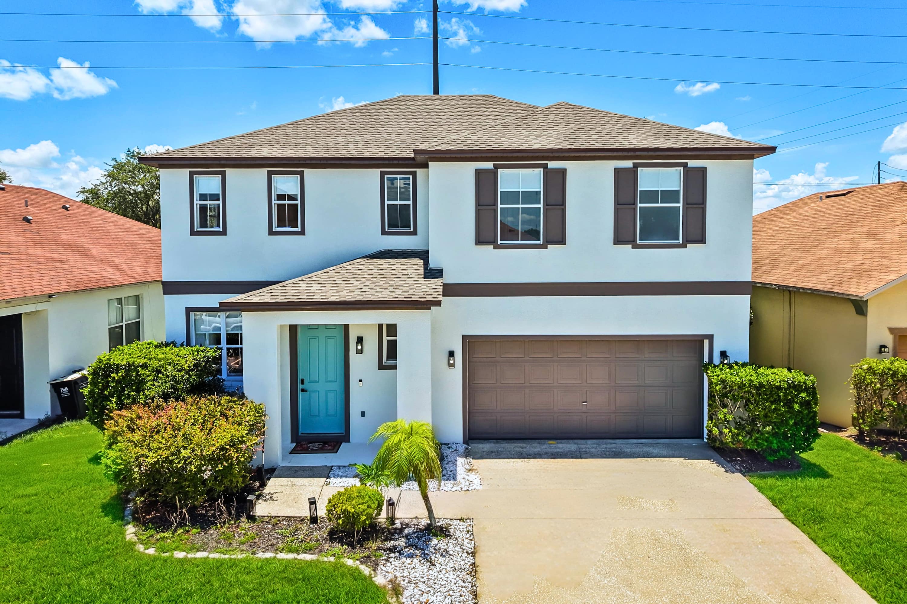 A beautiful two-story property featuring a private driveway with plenty of parking space for your group