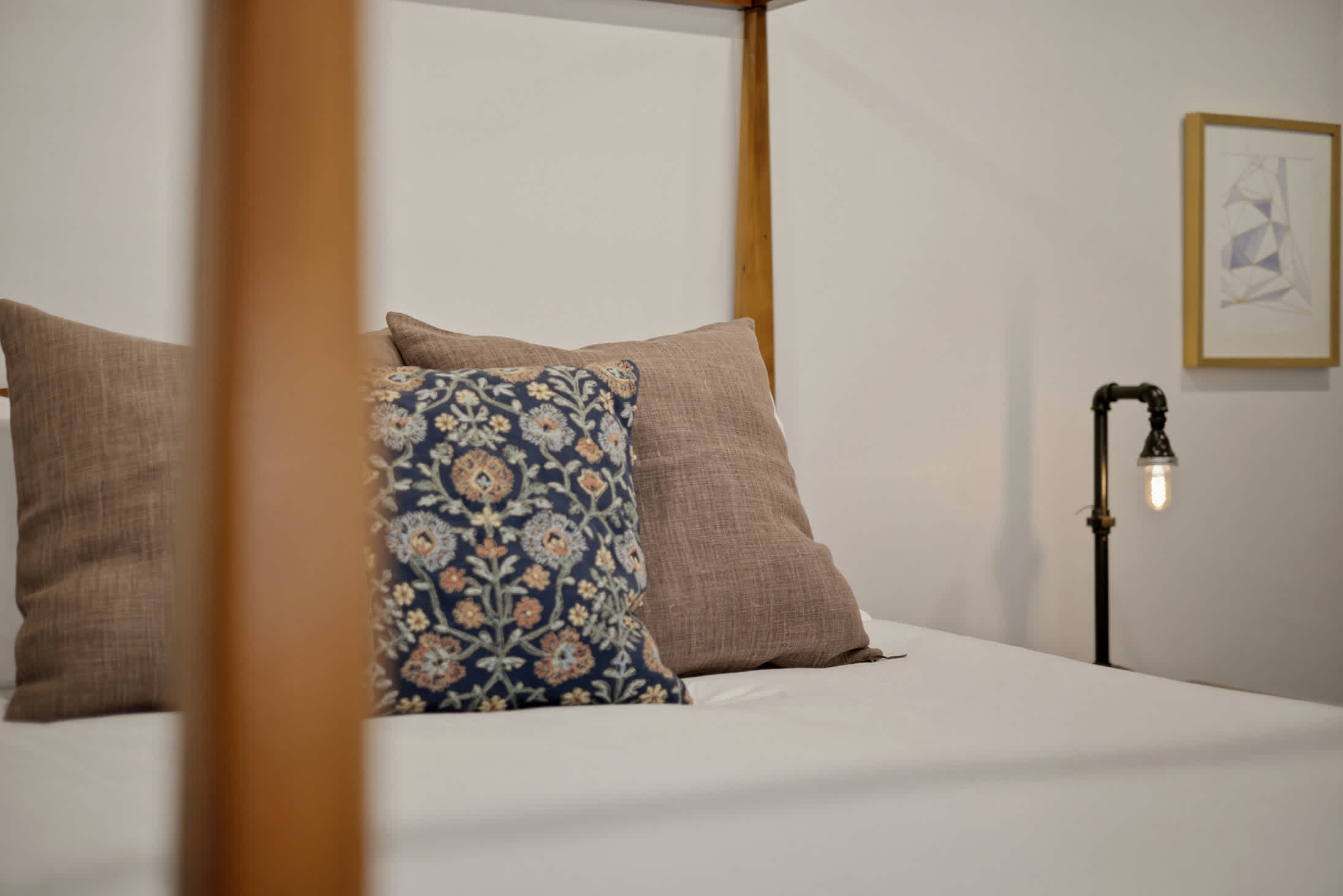 Canopy bed with soft linens for a comfortable night's rest.