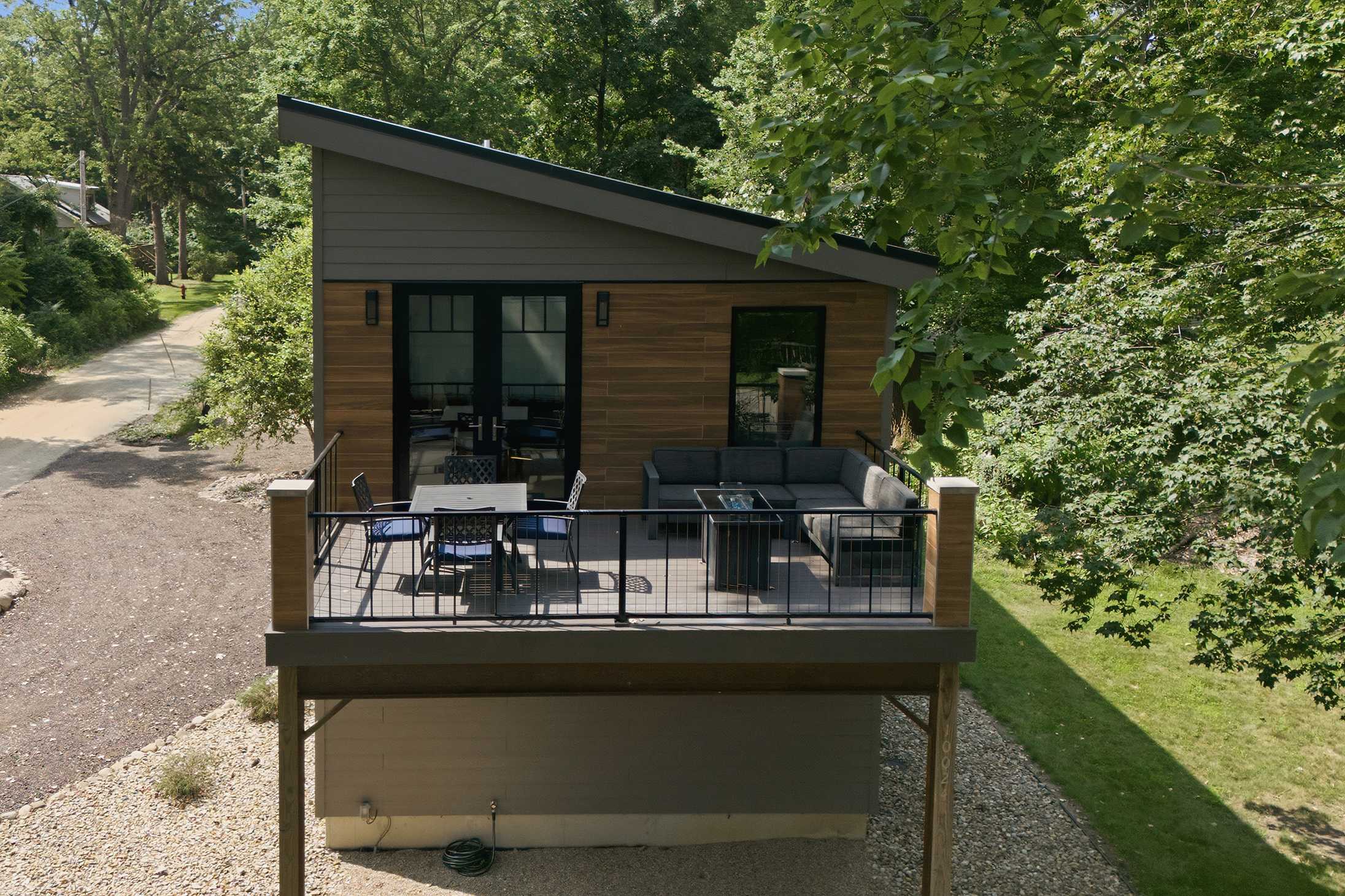 Elevated deck offers separate spaces for dining and outdoor lounging.