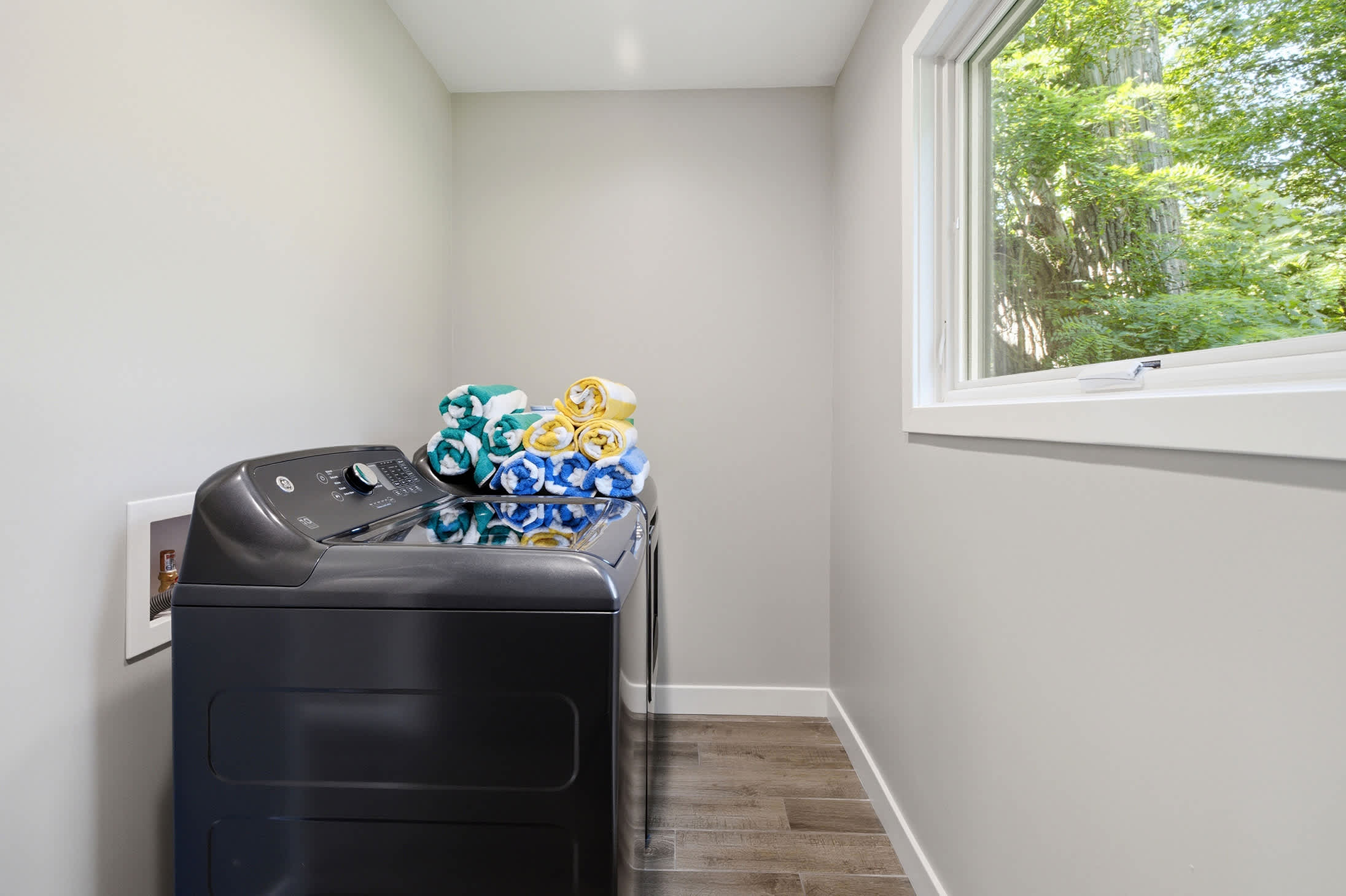 Dedicated laundry room with washer and dryer for added convenience.