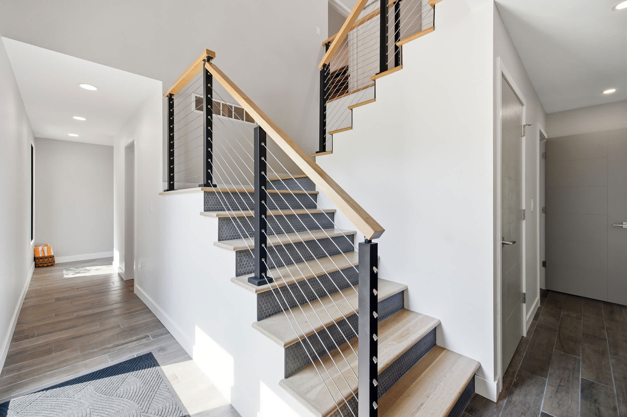 Welcoming entry with open staircase for easy access throughout the home.