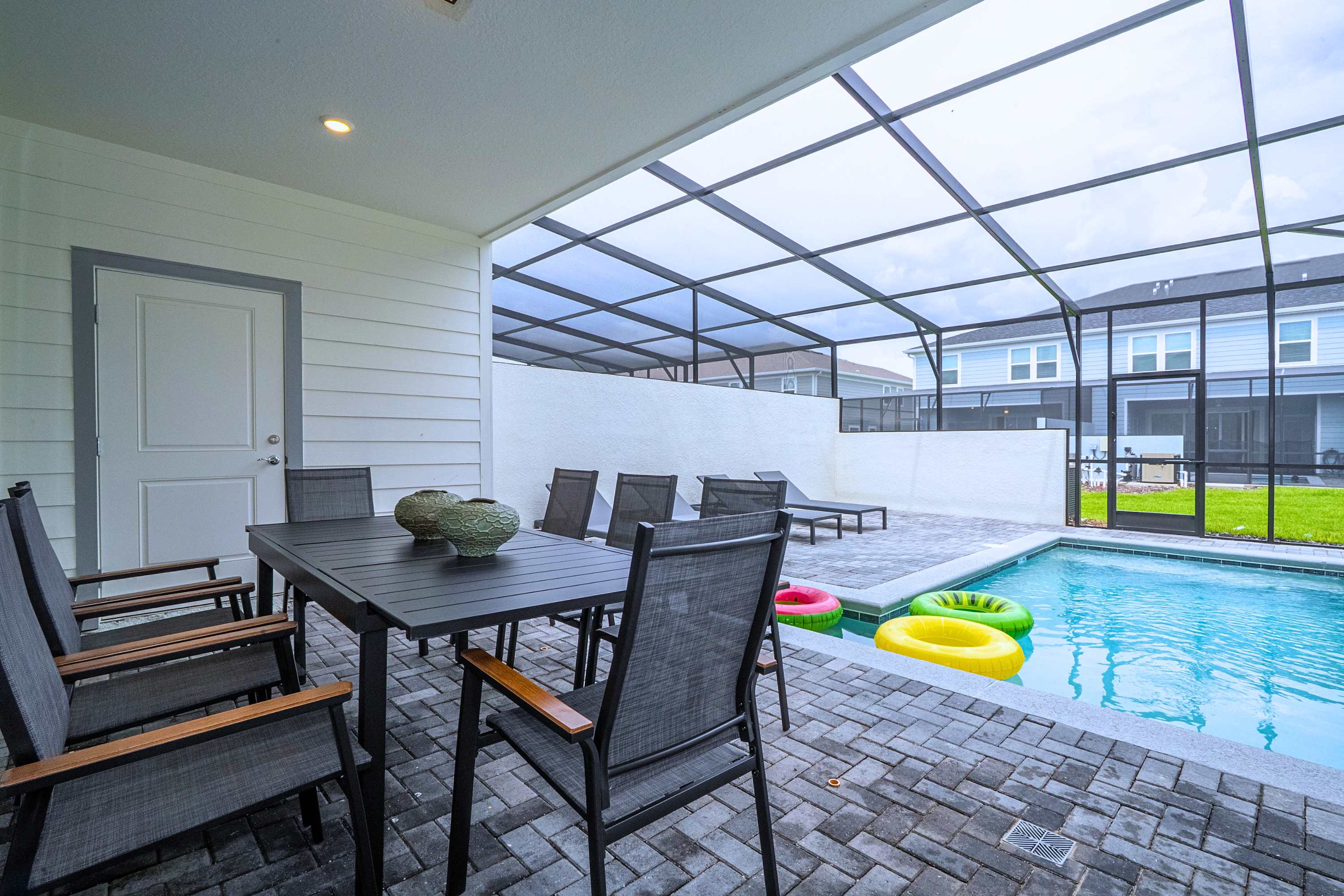 Enjoy family dinners at this spacious eight-seat dining area positioned directly alongside the pool for a relaxed, resort-style vibe