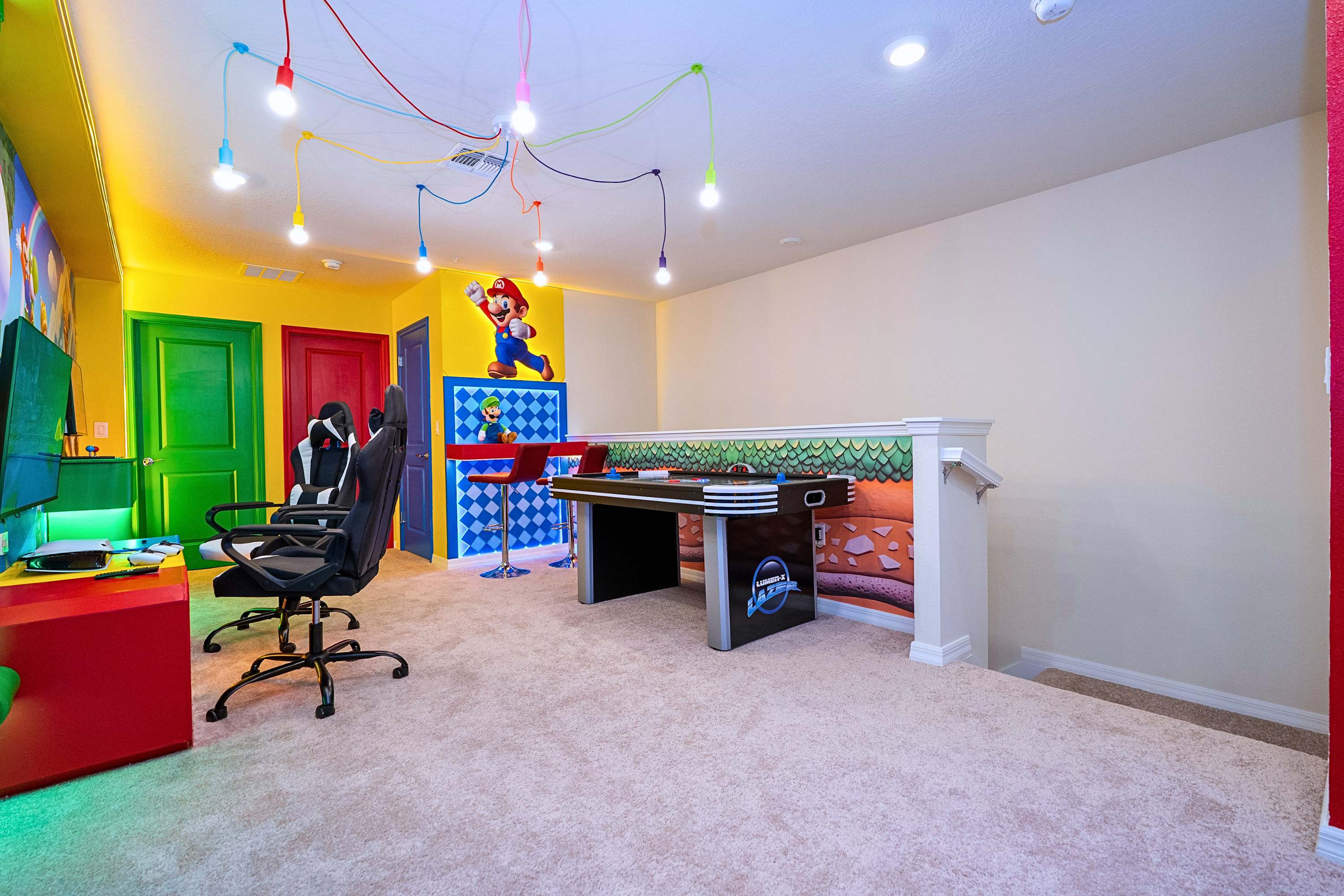 Keep everyone entertained with air hockey, retro arcade games, a console setup, and a comfortable high-chair seating area to watch the fun