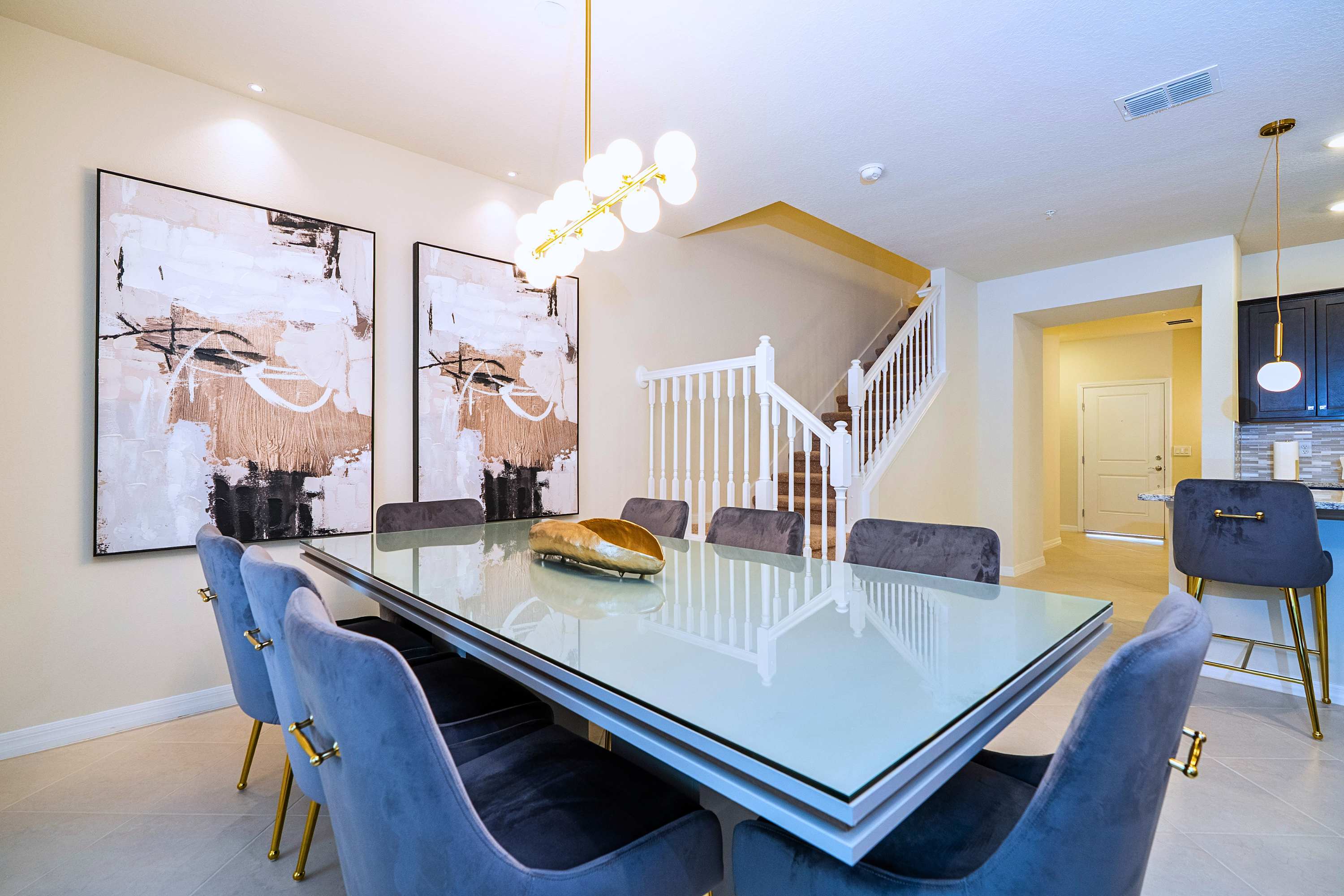 Gather around this stylish six-person dining table, illuminated by a stunning designer chandelier that serves as the perfect centerpiece