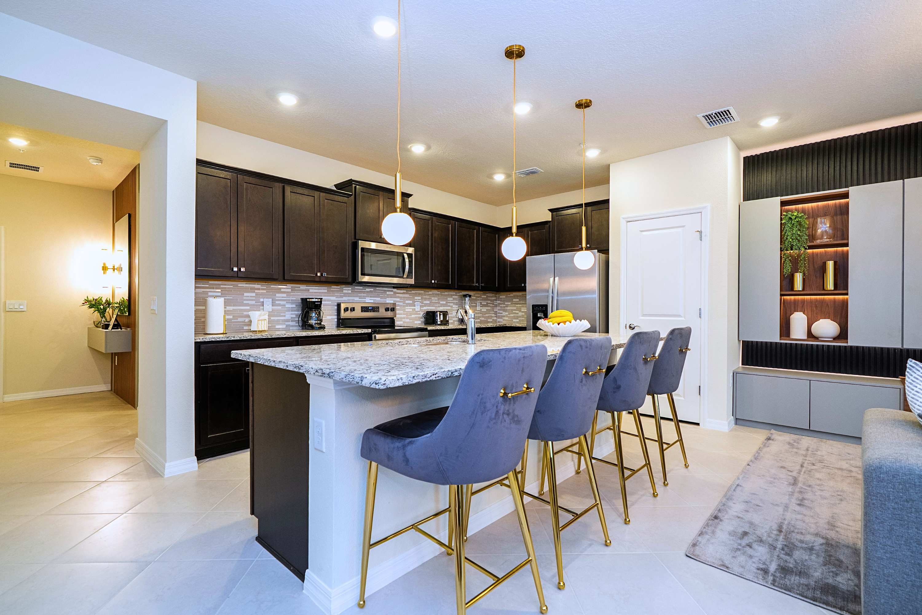 The ultimate breakfast bar and prep space, showcasing a large central island complete with four stylish high chairs
