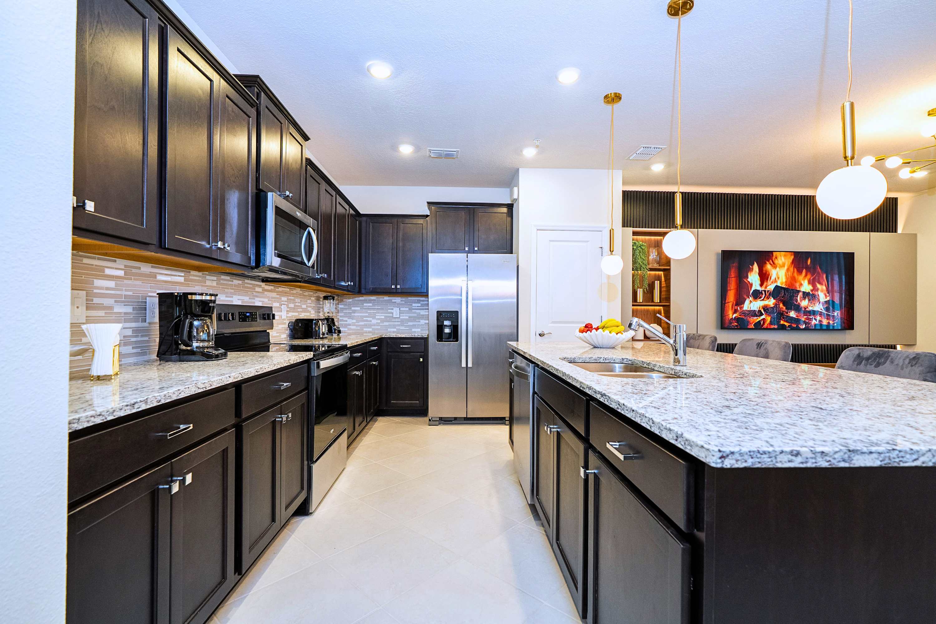 A beautifully designed kitchen layout highlighted by a large central island that offers both ample workspace and extra seating