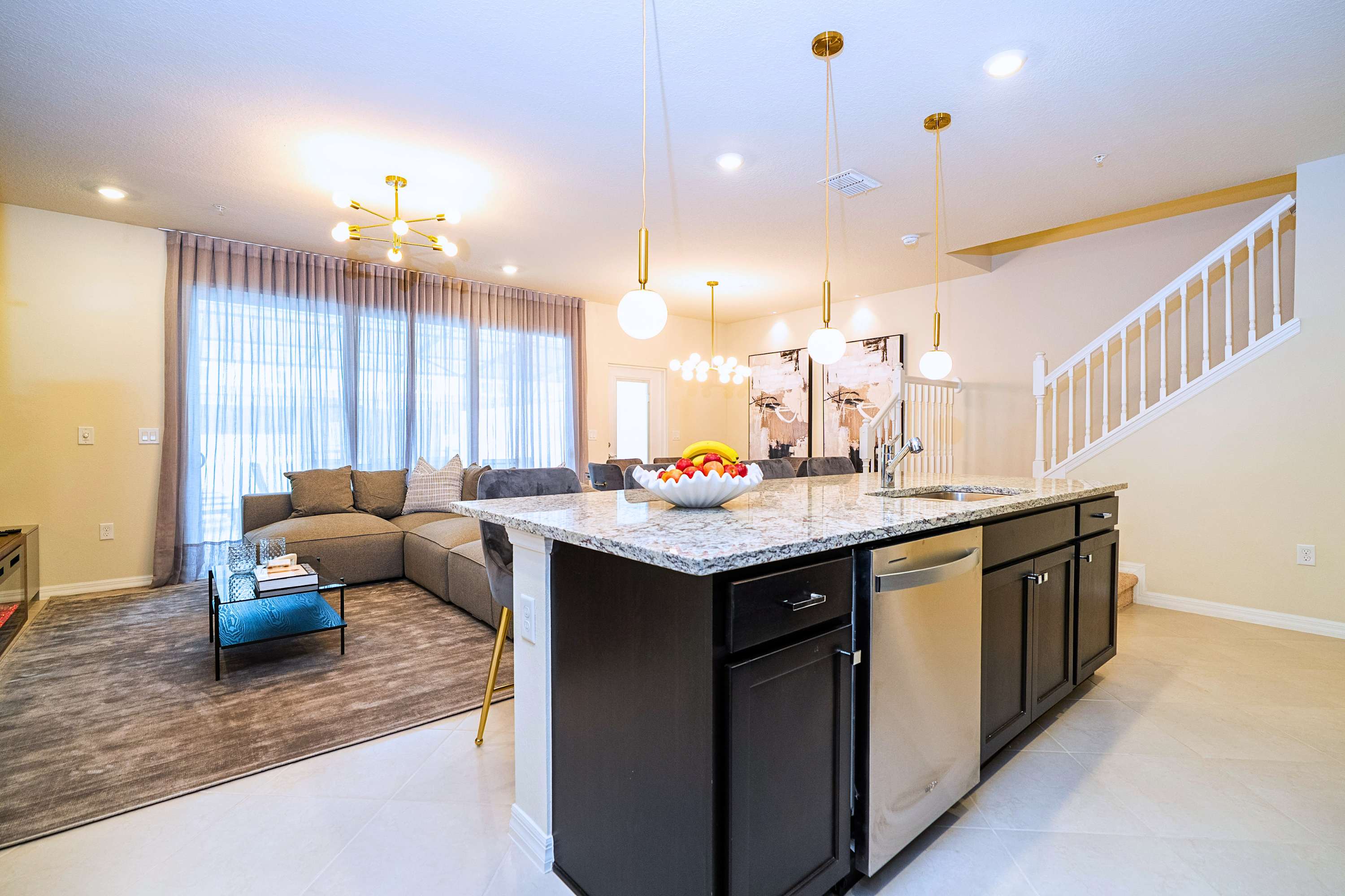 A seamless transition from the central island breakfast bar right into the heart of the cozy living space