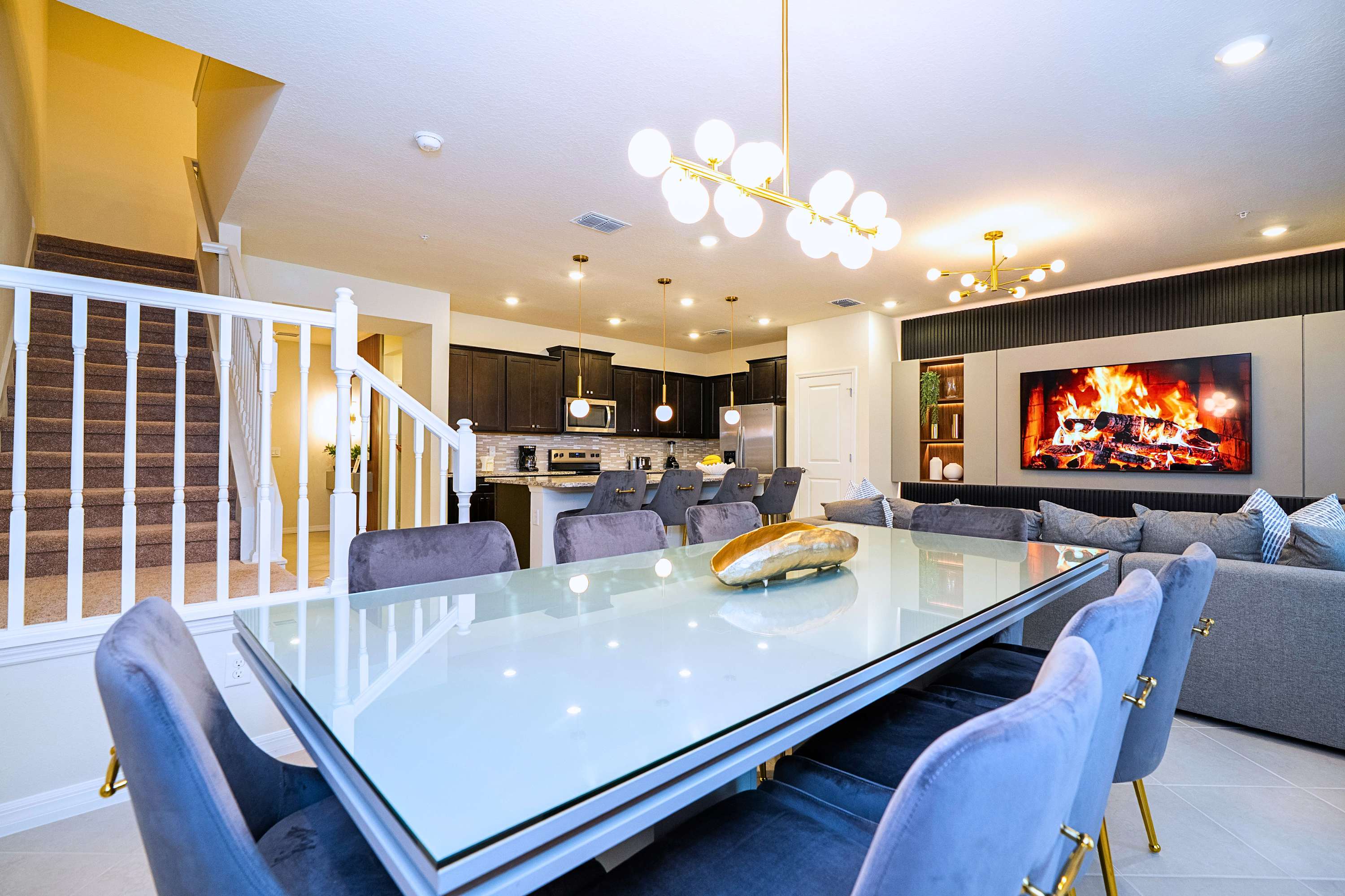 See how it all connects: the dining space, TV lounge, kitchen, and the staircase to the second floor