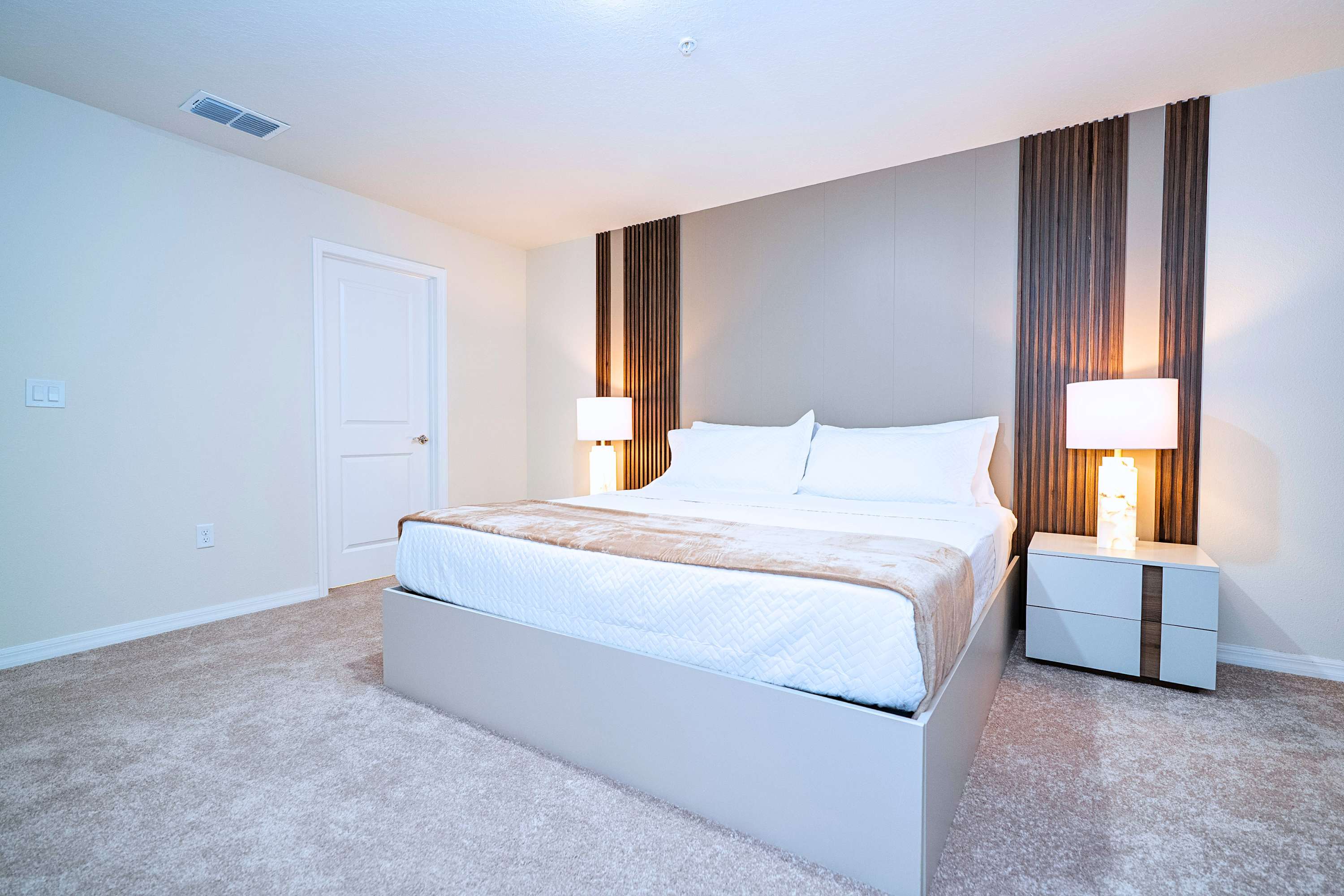 Unwind in a king bed with high-quality sheets and elegant bedside lighting on both sides