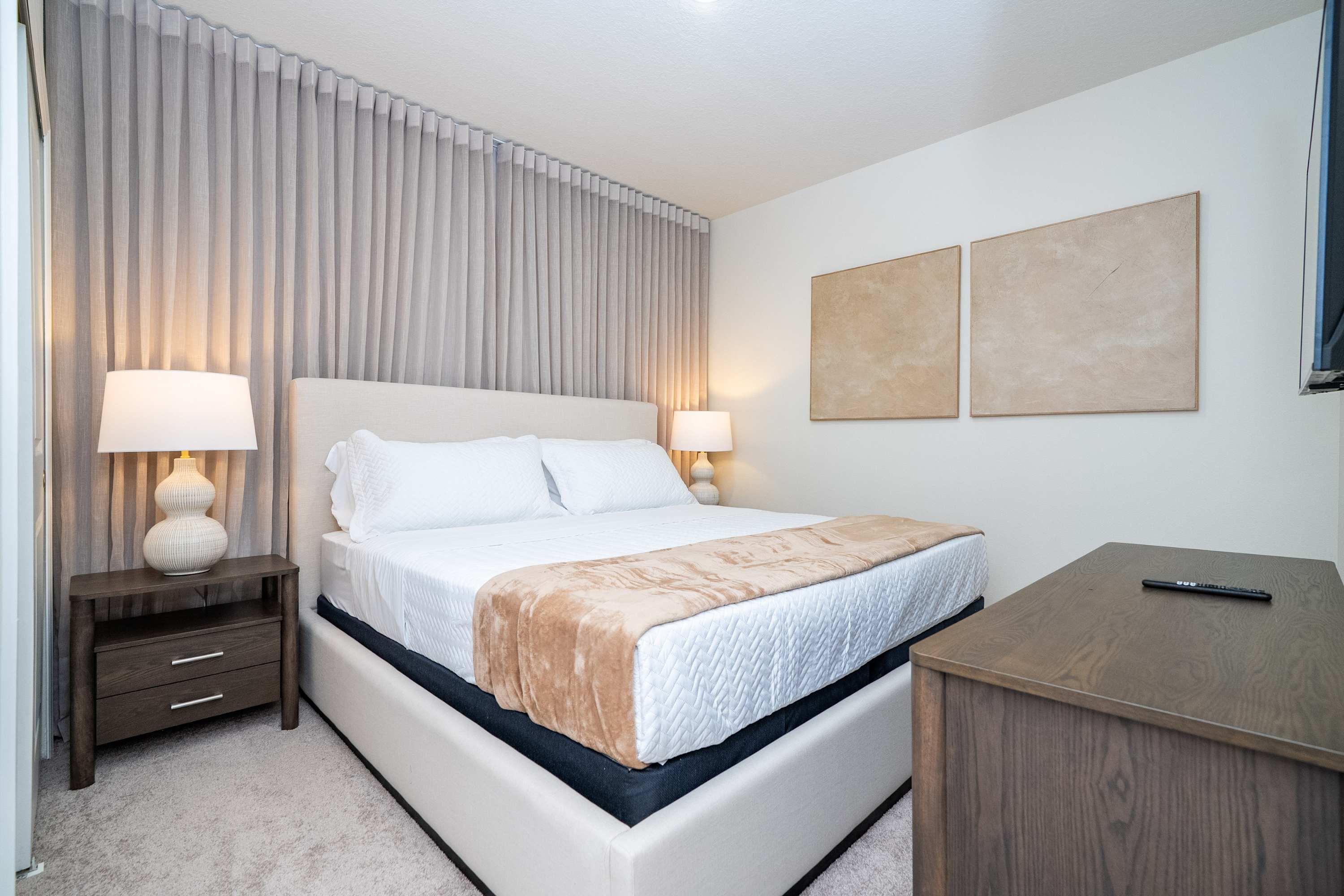 Unwind in this stylish king room, complete with cozy side lamps, premium curtains, and ample cupboard storage