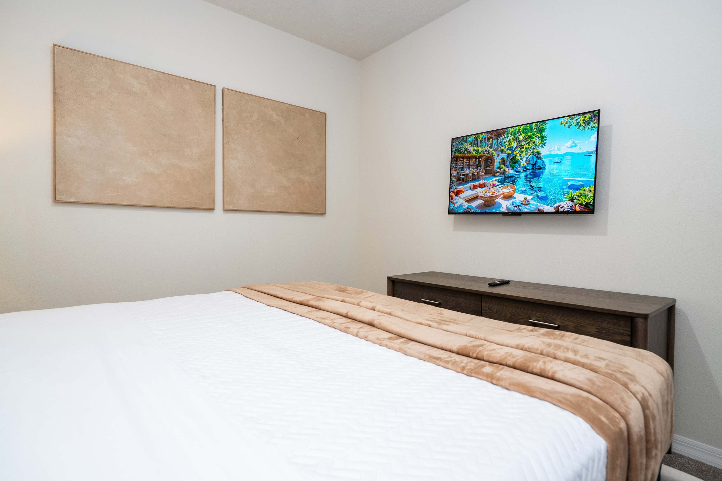 Enjoy late-night movies on the wall-mounted smart TV right from the comfort of your king bed