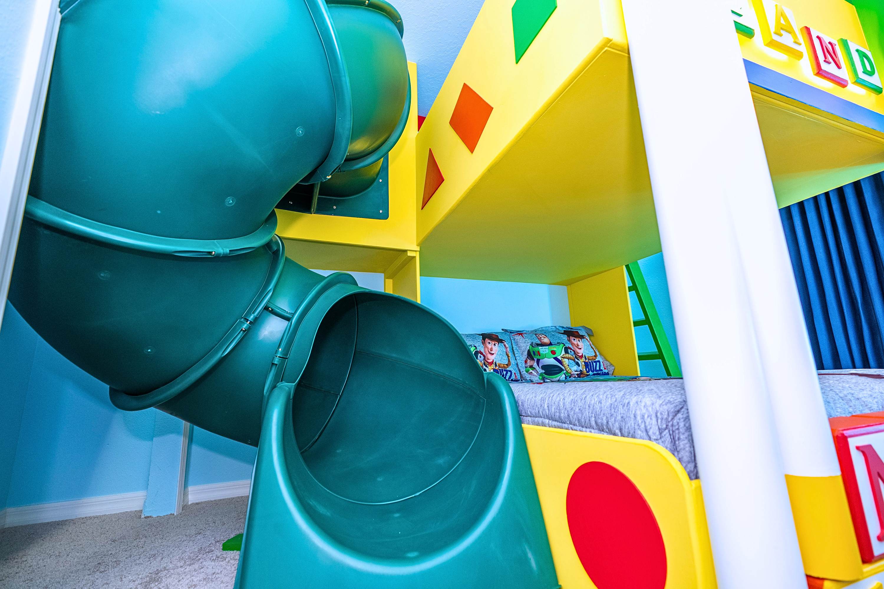 An immersive Toy Story kids' paradise, featuring a fun bunk bed and an exciting built-in slide