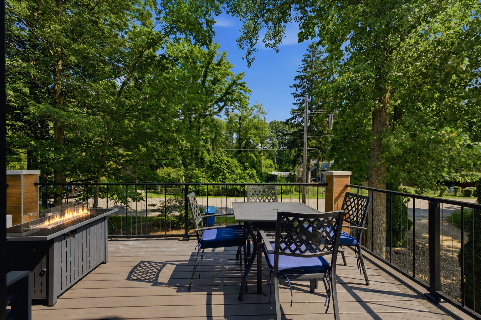 Upper deck with outdoor dining and fire table for meals and evening gatherings.