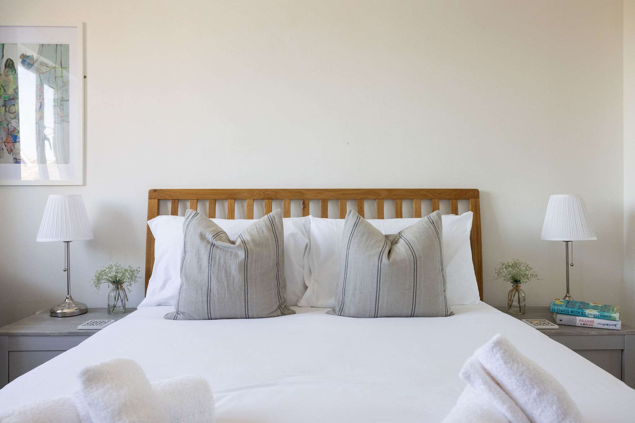 Peaceful king bedroom featuring crisp bedding and calming décor for a relaxing seaside stay.