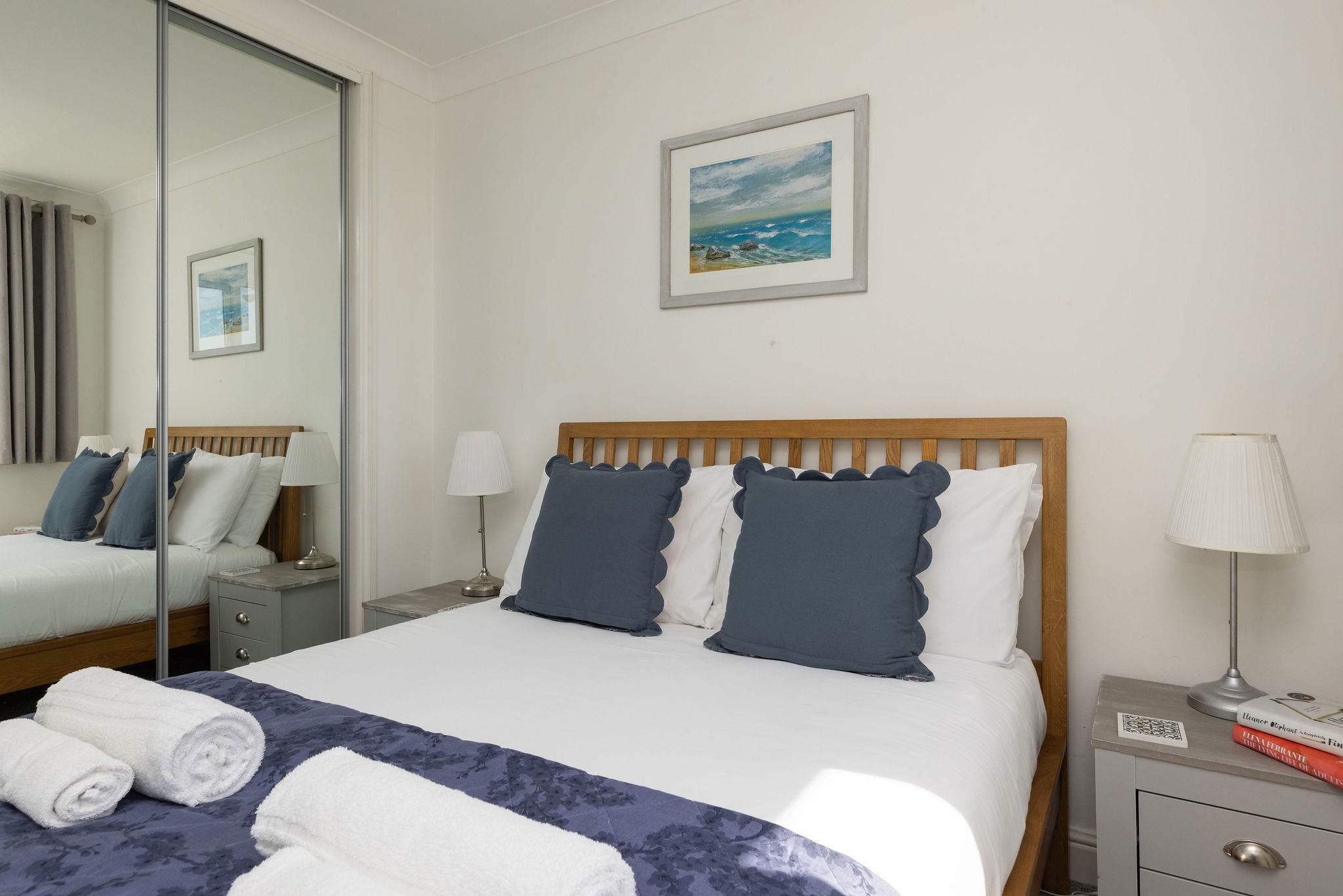 Bright and cosy double bedroom with soft linens, perfect for a relaxing coastal retreat.
