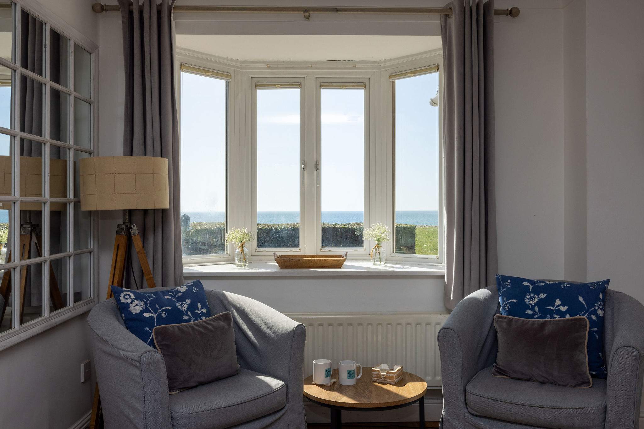 Relax with uninterrupted sea views from this peaceful coastal sitting area filled with natural light.