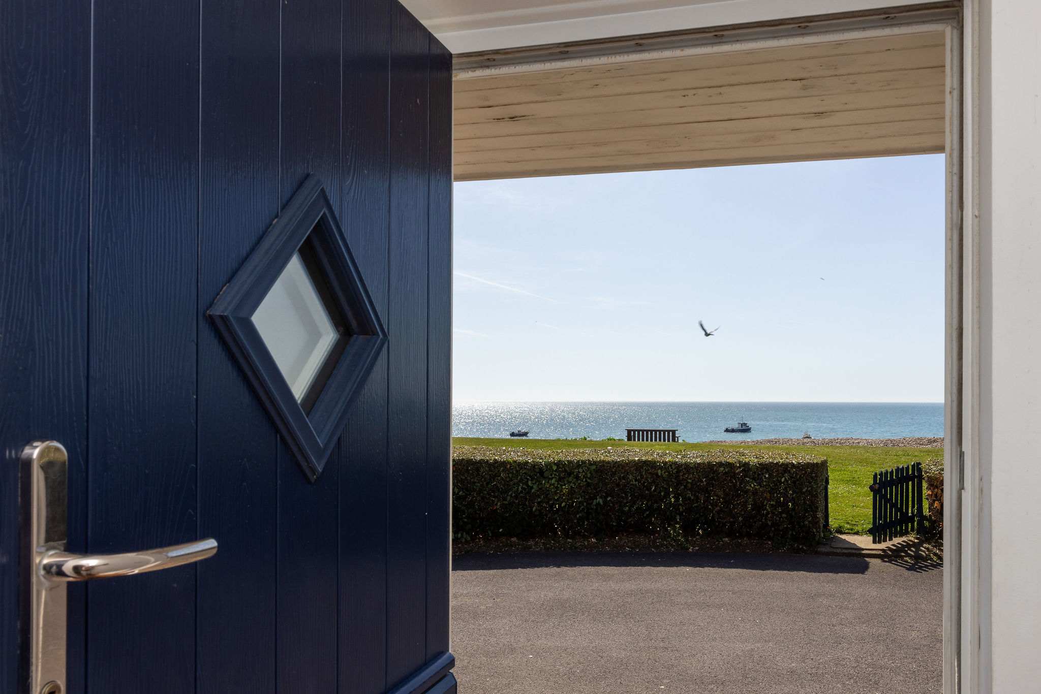 Welcoming entrance opening to breathtaking seafront views and your unforgettable beachfront holiday home.