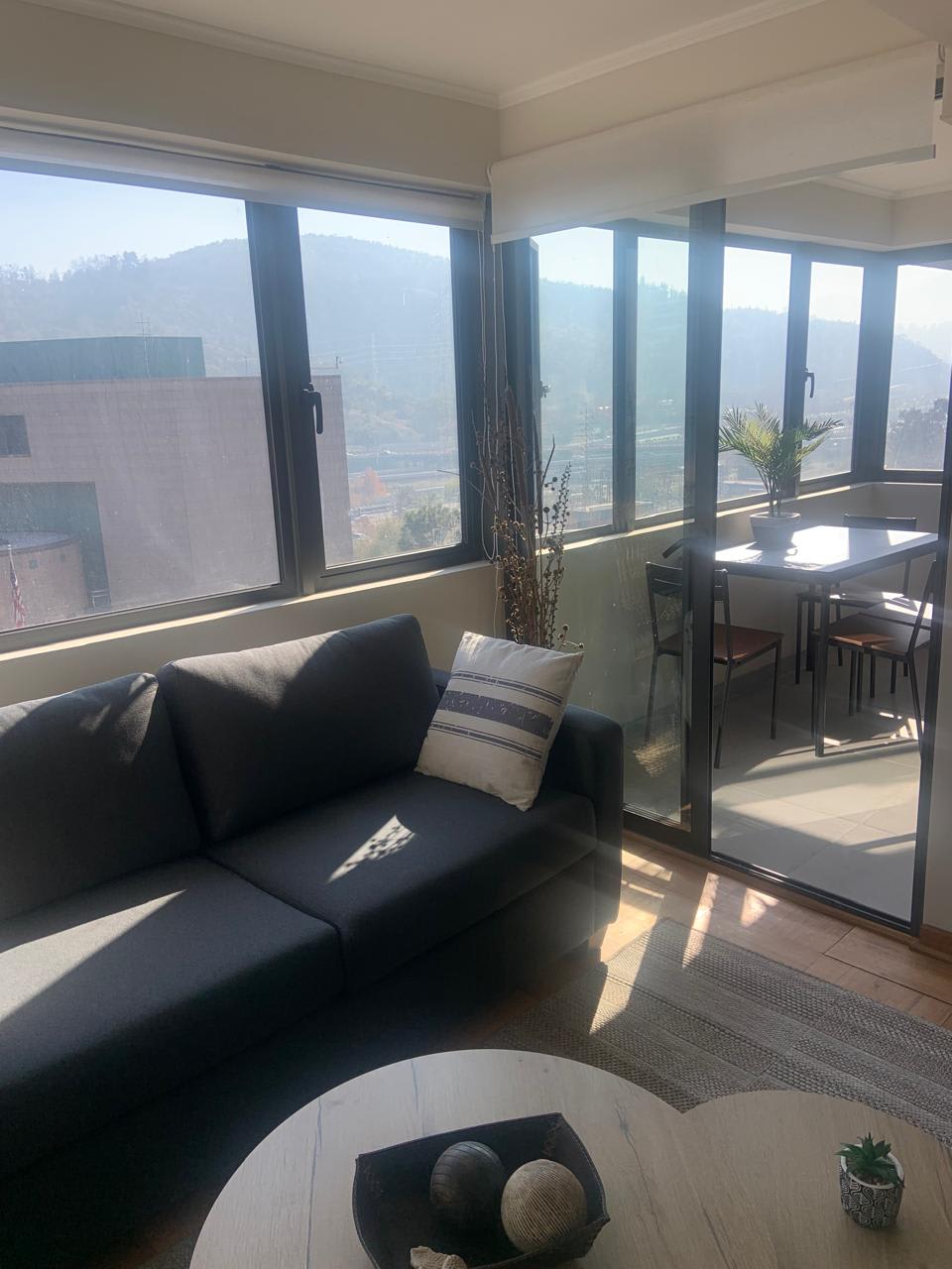 Relax in this sunlit living area with stunning mountain views, perfect for unwinding after a day of exploration.