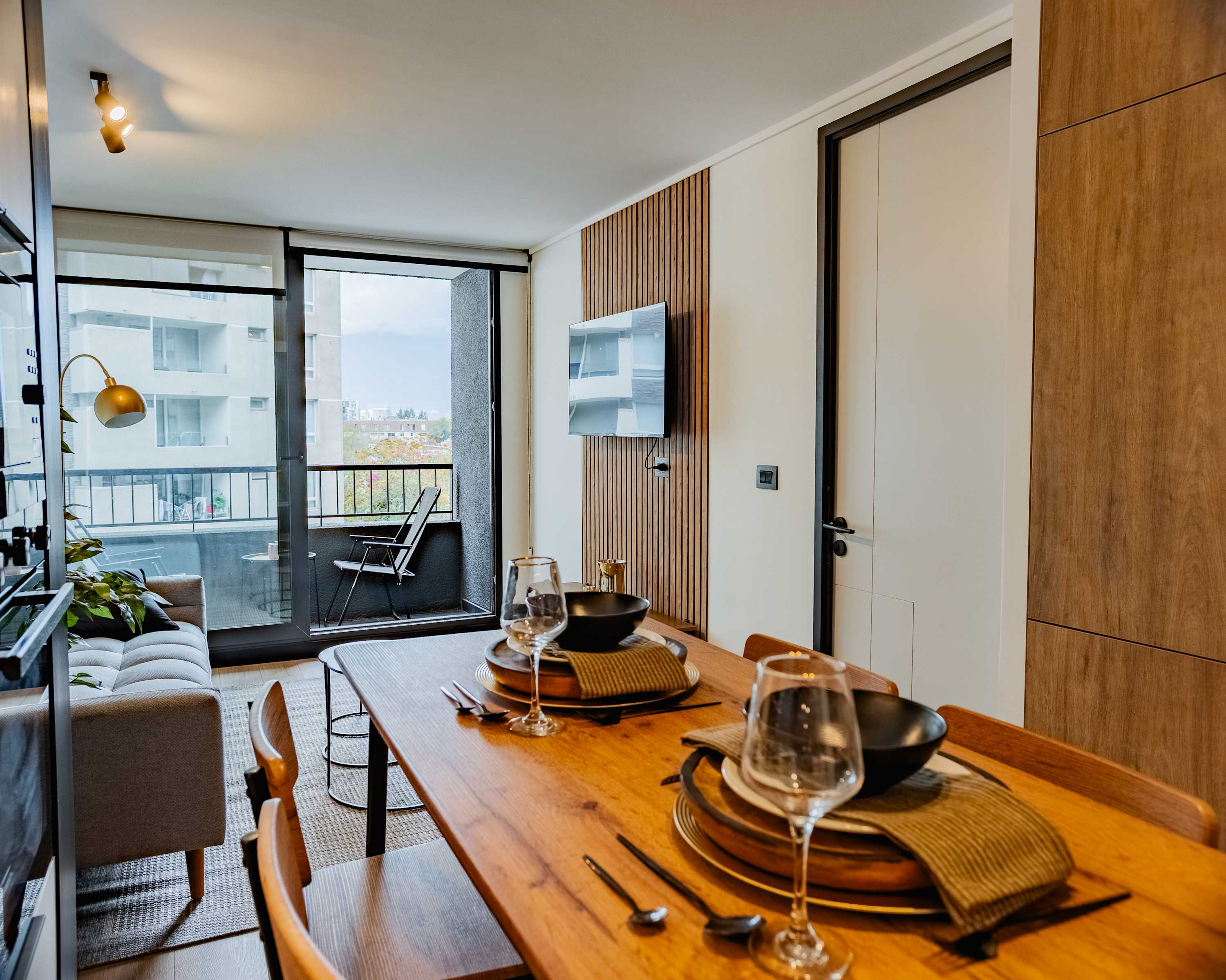 Enjoy a cozy meal with a view in this stylish studio apartment featuring a private balcony and modern amenities.