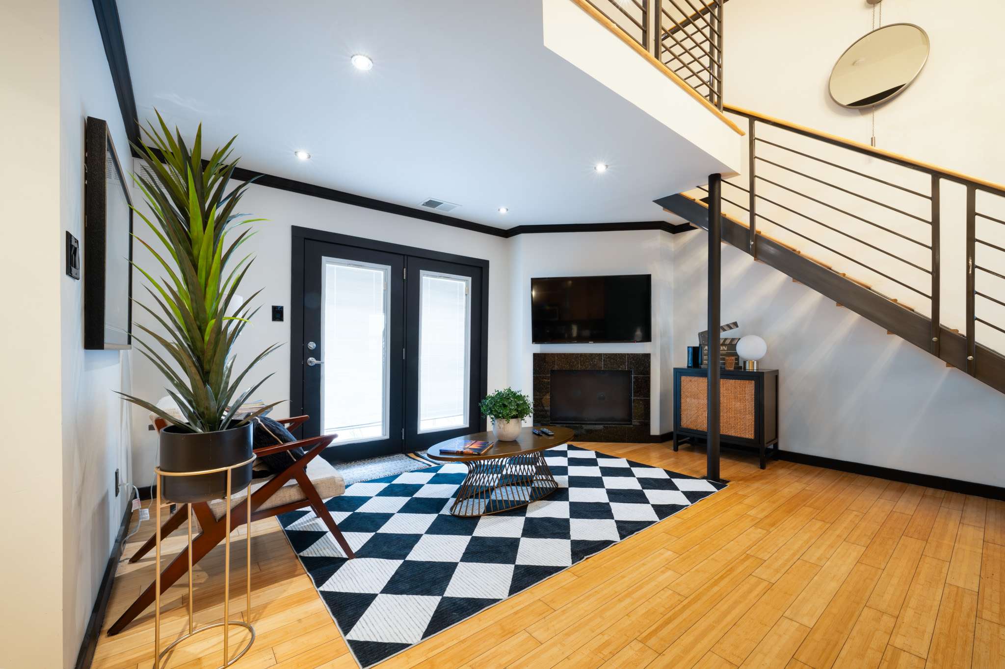 Experience modern elegance in this stylish living room with a chic geometric rug and sleek decor. Perfect for relaxing and entertaining.