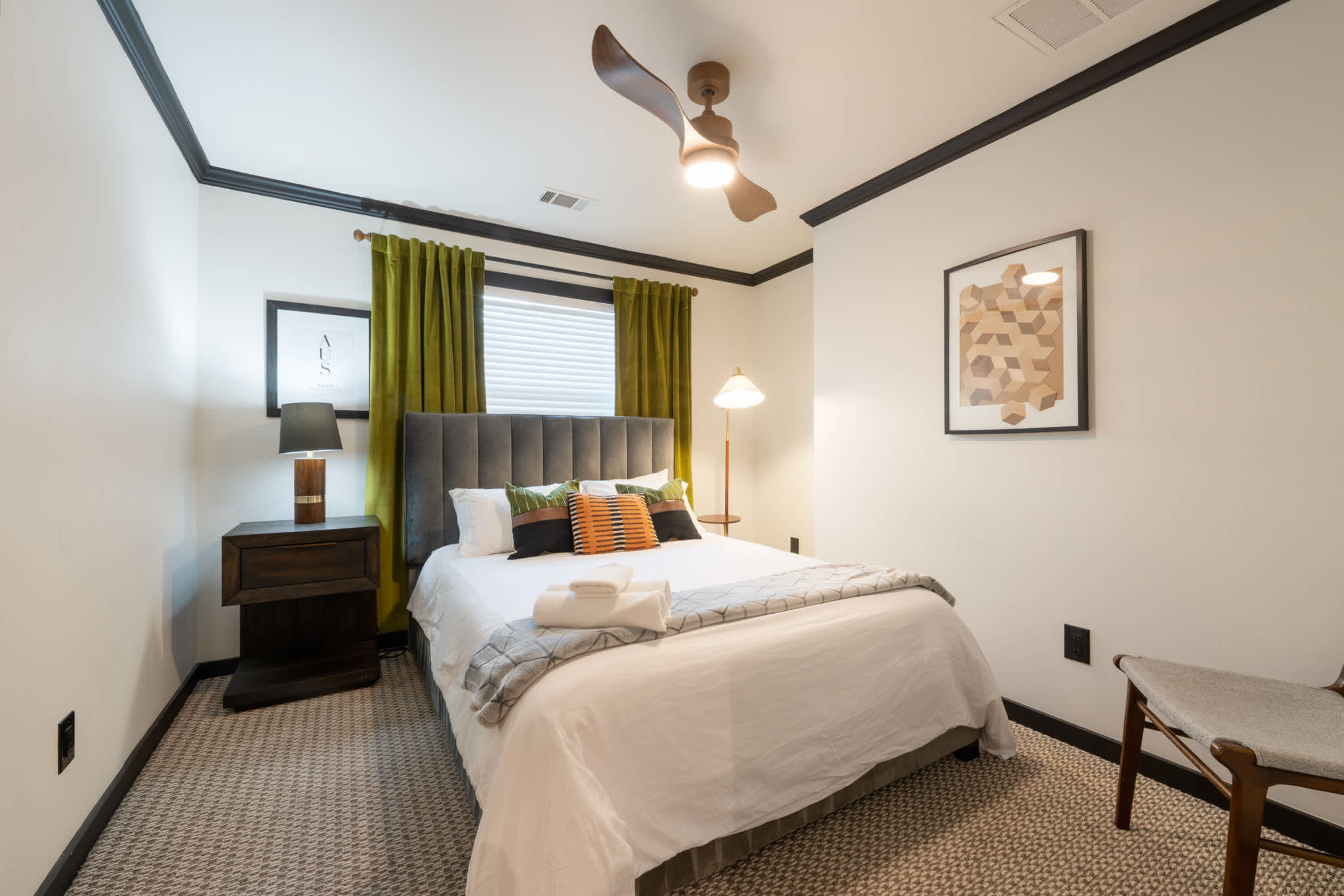 Relax in this stylish bedroom featuring a plush bed, chic decor, and cozy lighting—perfect for a restful stay.