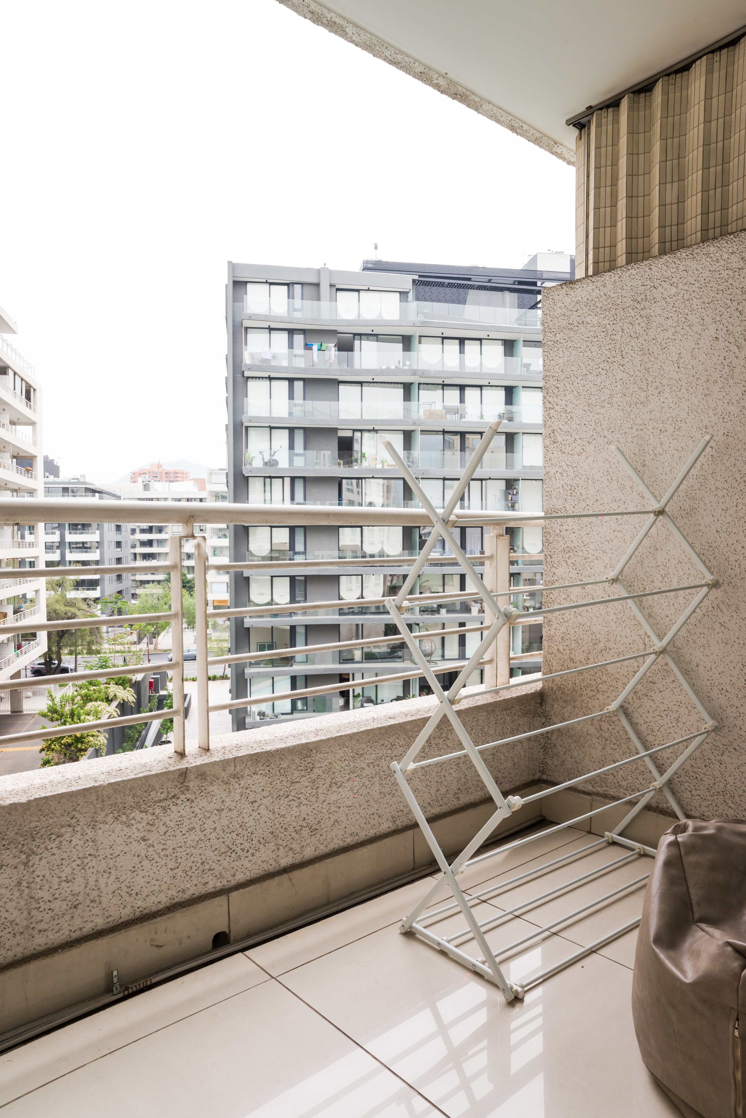Private balcony with urban views and a bright open outlook over Santiago’s modern residential buildings.
