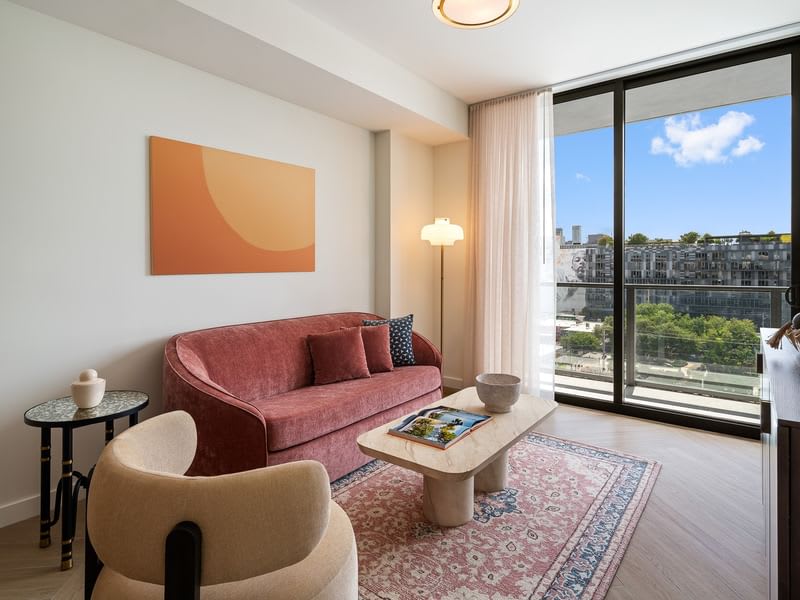 Cozy and stylish living area with a stunning city view, perfect for relaxation.