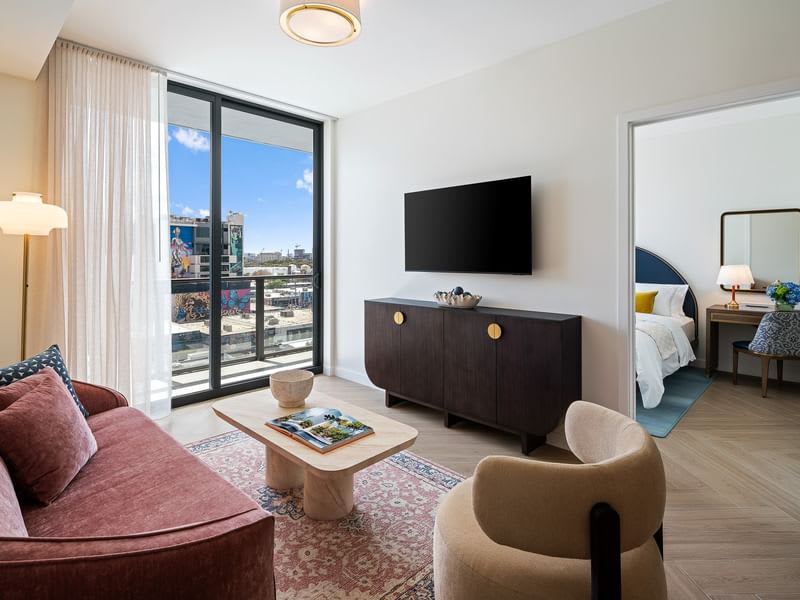 Relax in this stylish living room with a stunning city view, plush seating, and modern decor. Perfect for unwinding after a day of exploring.