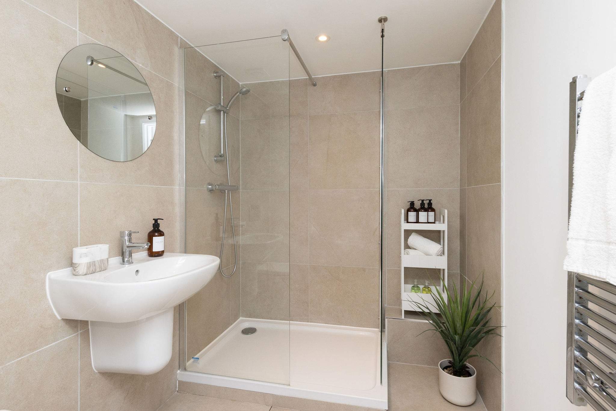 Contemporary walk-in shower room with fresh towels for a comfortable and relaxing stay.
