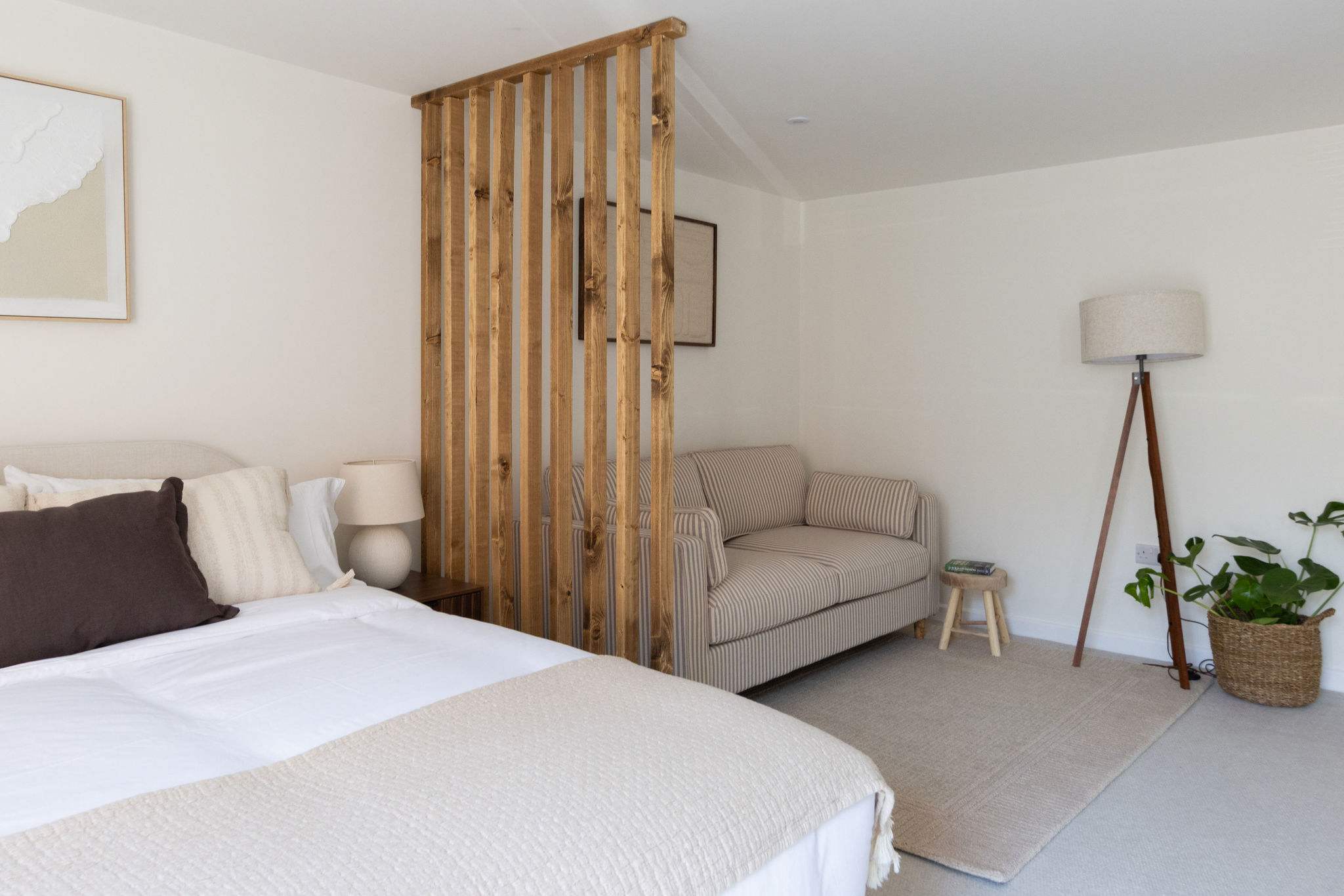 Comfortable king bedroom with relaxing seating area, perfect for families or longer holiday stays.