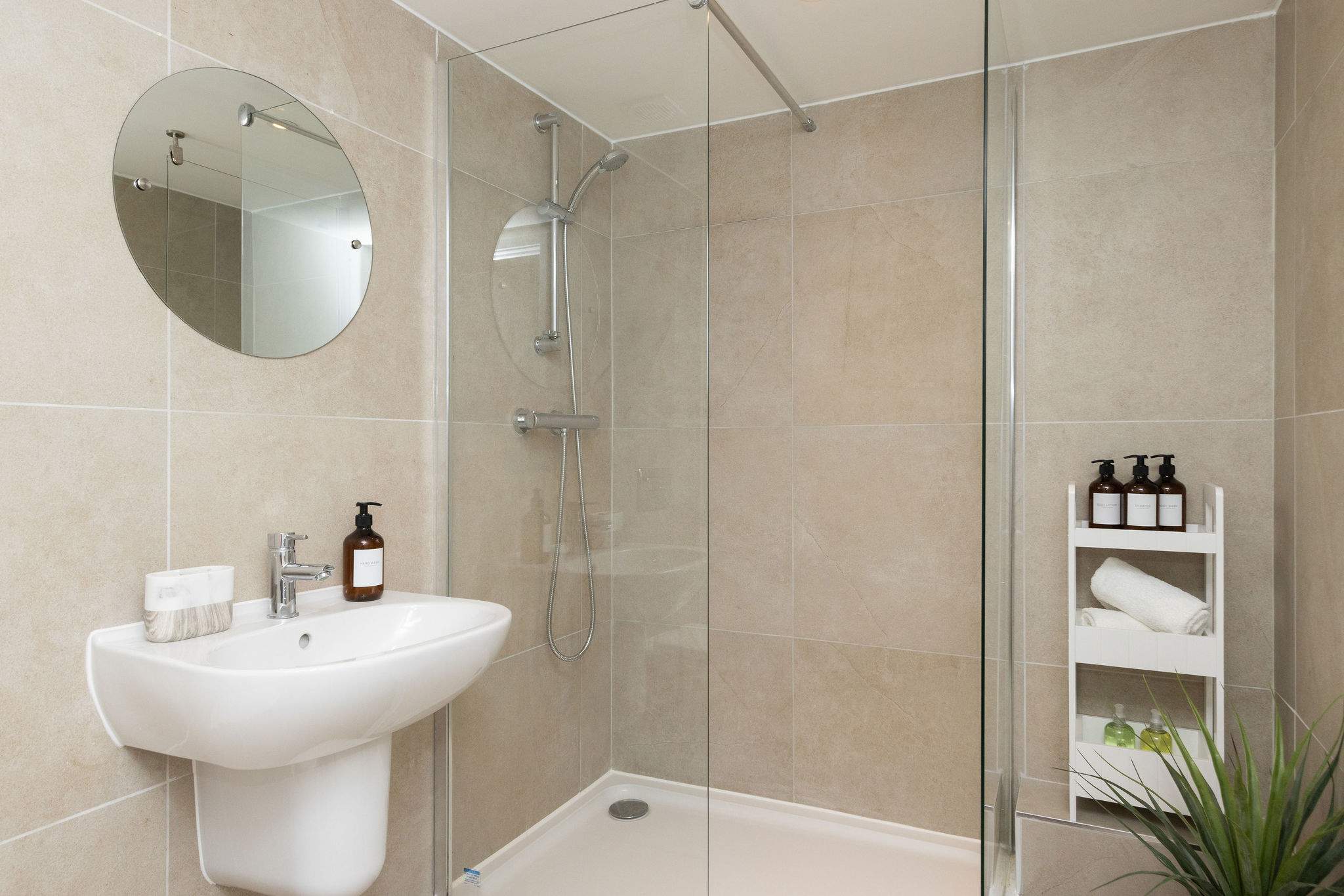 Contemporary walk-in shower room with modern finishes, fresh towels and thoughtful holiday essentials.