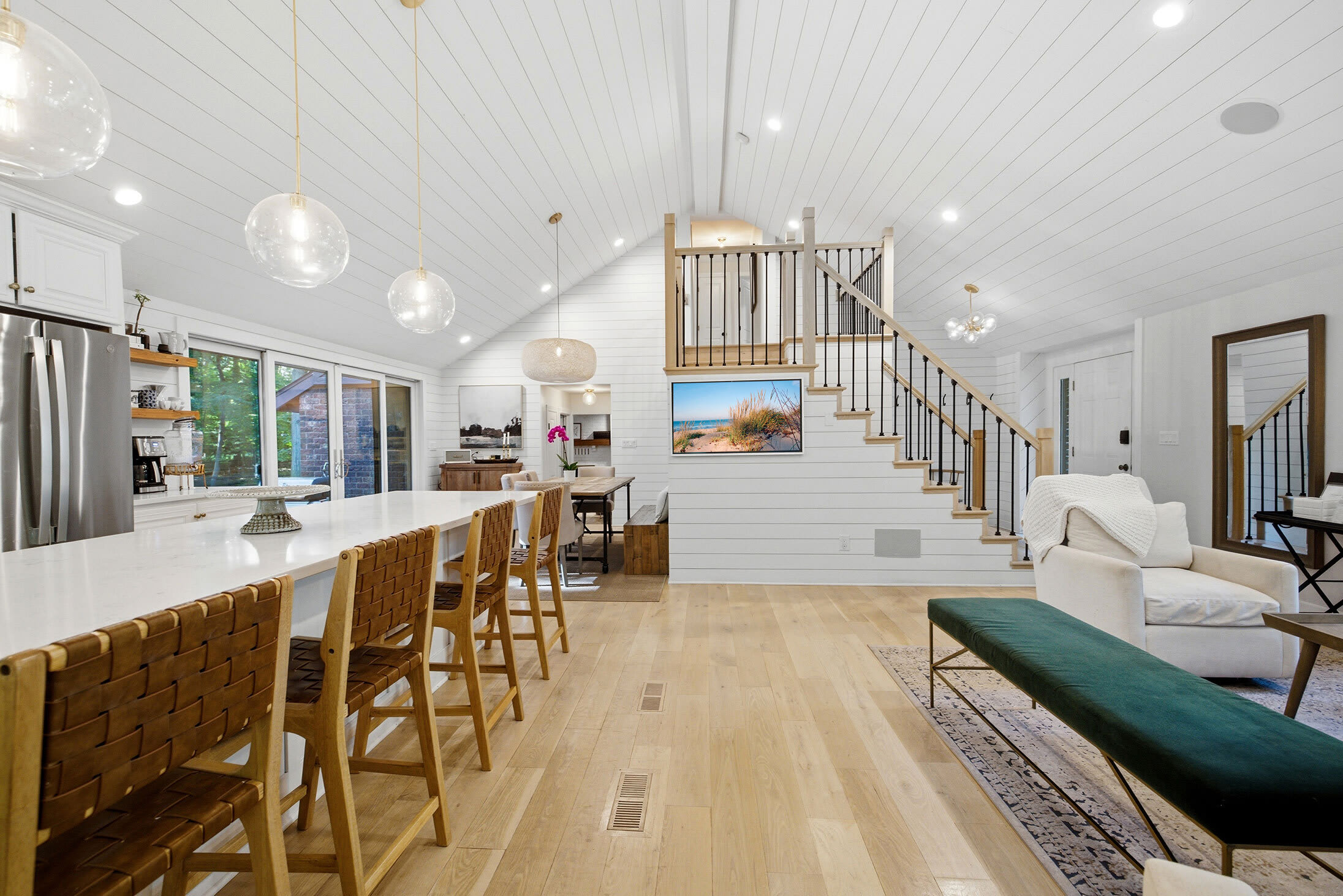 Open sightlines from kitchen to lounges make hosting seamless.